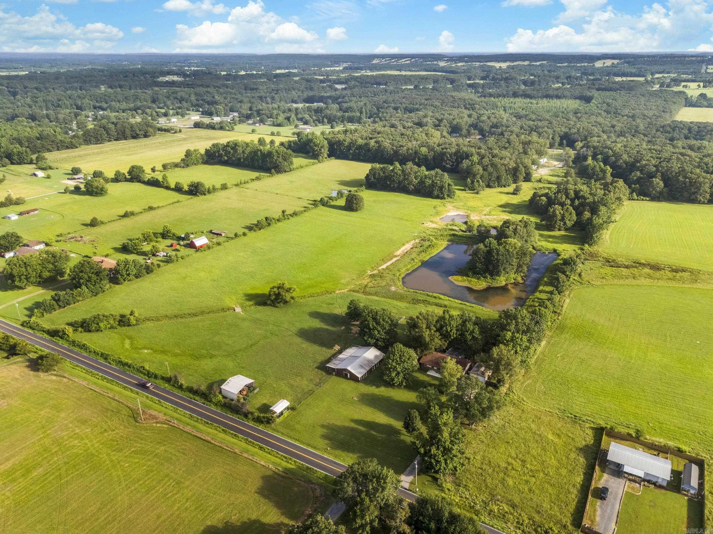 Escape to your own private retreat! This stunning 3-bedroom, 2-bath home on 20 acres offers everything you need: a gorgeous deck for unwinding, a spacious barn, two sparkling ponds, and a sunroom with A/C for year-round comfort. Plus, a dedicated office off the master bedroom makes working from home a breeze!
