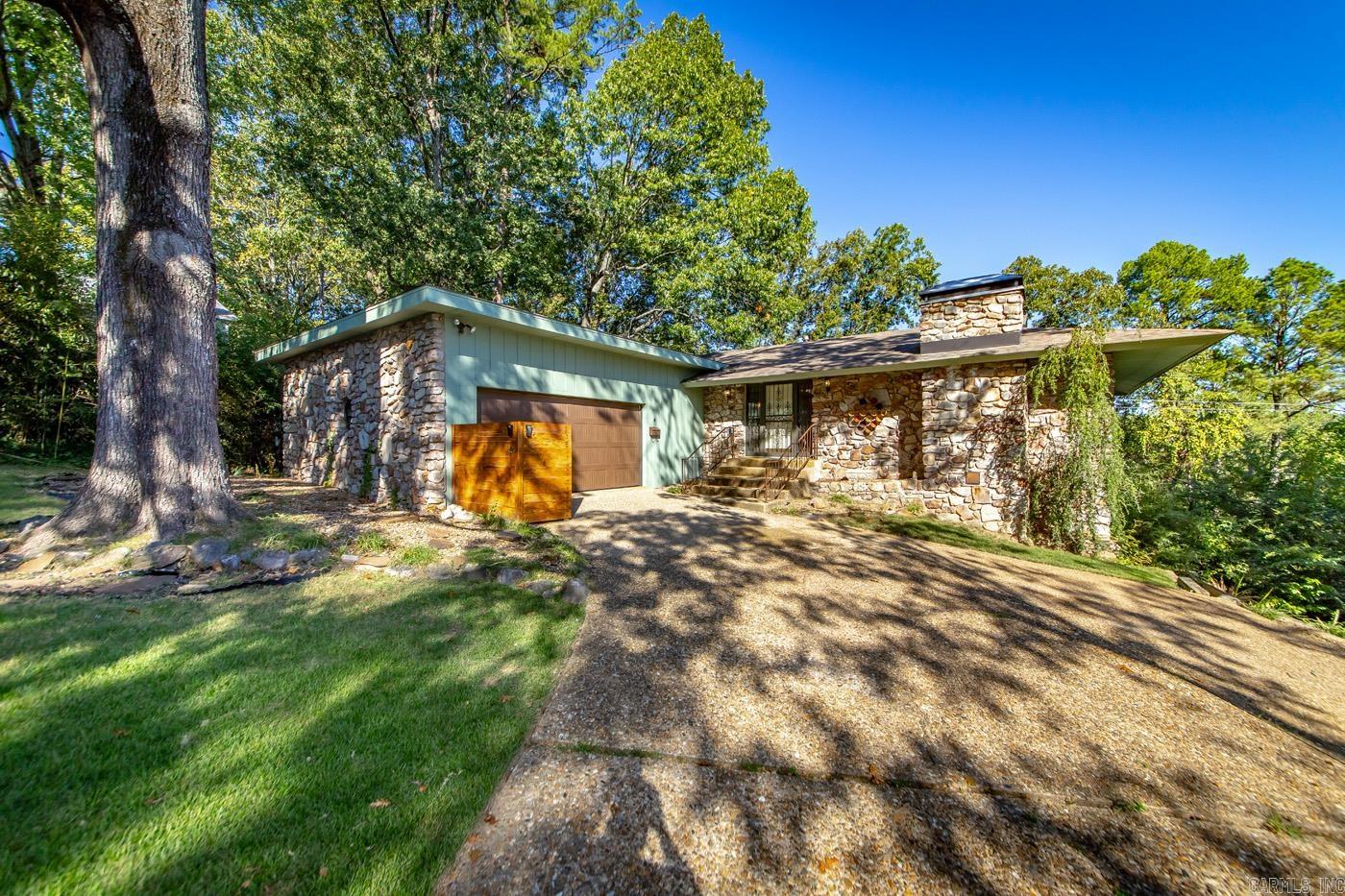 Check out this great buy in Leawood! This spacious home offers four large bedrooms and two and a half bathrooms with the primary on the main floor. You will love the large windows throughout, letting you enjoy the elevated views in the rear of the home. There is a large kitchen featuring granite counters, stainless steal appliances, including two refrigerators ensuring you never run out of space. This property is also on an oversized lot with a separate driveway and parking pad to the right of the home which allows easy access to the lower level. The backyard has a non-functioning in-ground pool and is the reason this listing is being sold as-is. Agents please see remarks.