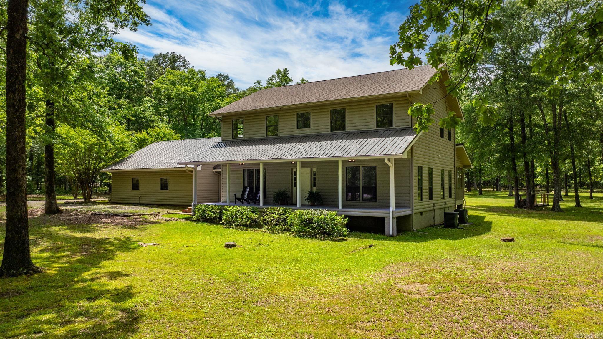 A Rare Find: Level 5-Acre Estate with Pond, MIL Quarters, Shop & More! Welcome to your dream retreat! Situated on 5 flat, usable acres with a peaceful pond, this one-of-a-kind property offers a perfect mix of comfort, functionality, and privacy. The home features 5 spacious bedrooms and 3.5 bathrooms with an open floor plan ideal for modern living and entertaining. All new interior paint and brand-new carpet give the home a fresh, move-in-ready feel, while custom built-ins and a large walk-in pantry with handcrafted cabinetry add style and convenience. Even better—2 brand-new HVAC systems with a 10-year warranty ensure comfort and peace of mind for years to come. One of the standout features is the attached 900 sq ft MIL quarters, with a full kitchen, perfect for extended family or guests with tons of storage space above. For hobbyists or anyone needing extra space, the property features a 2-car garage/shop, a separate storage building, and ample storage in two attics plus additional space beneath the home. And for added peace of mind, there’s a dedicated storm shelter. This updated and versatile estate is just minutes from everything you need. Schedule a showing today