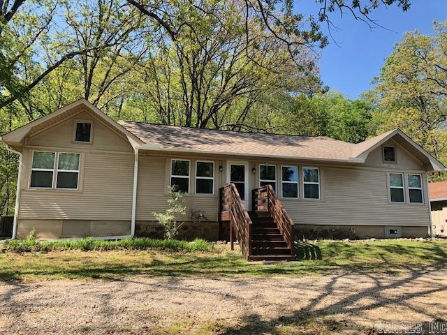 What a great opportunity to purchase two homes selling as a package. The main house has 3 bedrooms and 2 full baths and an amazingly large main living area. Its open and inviting gathering space has vaulted ceiling and decorator nooks. And you get an additional sweet 1 bedroom, 1 bath guest cottage next door with generous amount of living space. Great set up for those needing additional living quarters full time or for monthly rental income. Conveniently located just minutes from major shopping, medical facilities, bypass and Oaklawn. It has a fenced in backyard with a delightful flagstone sitting area where you can relax and enjoy the privacy of the expansive wooded hillside. Watch the deer and listen to the birds with your coffee. Current owner has done numerous improvements and upgrades: windows, roof, gutters with the new double garage and detached storage building being the most recent.