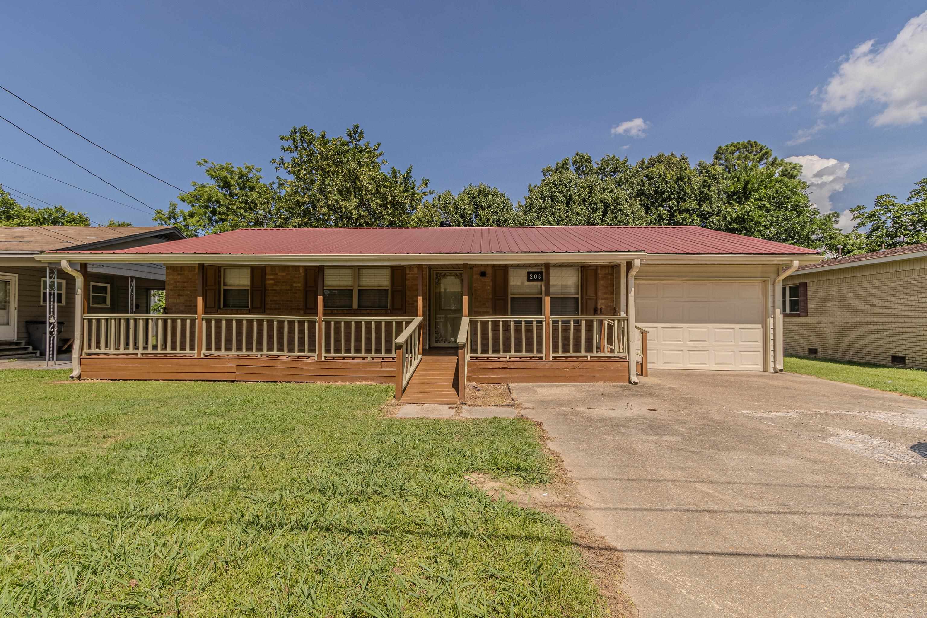 Updated and ready for new owners! As you drink sweet tea on the expansive front porch you will enjoy full shade with the metal roof and overhang providing a cool place to visit. The hardwood floors are gorgeous in this home, updated tile in kitchen, breakfast and laundry area, large patio out back, freshly painted inside and out, all nuetral decor and stainless new appliances, counters and even an adorable area to sit in the large bathroom. Single garage with auto opener, and you wont want to miss this one so call today! Sellers are offering one year warranty and $5,000 towards closing costs.