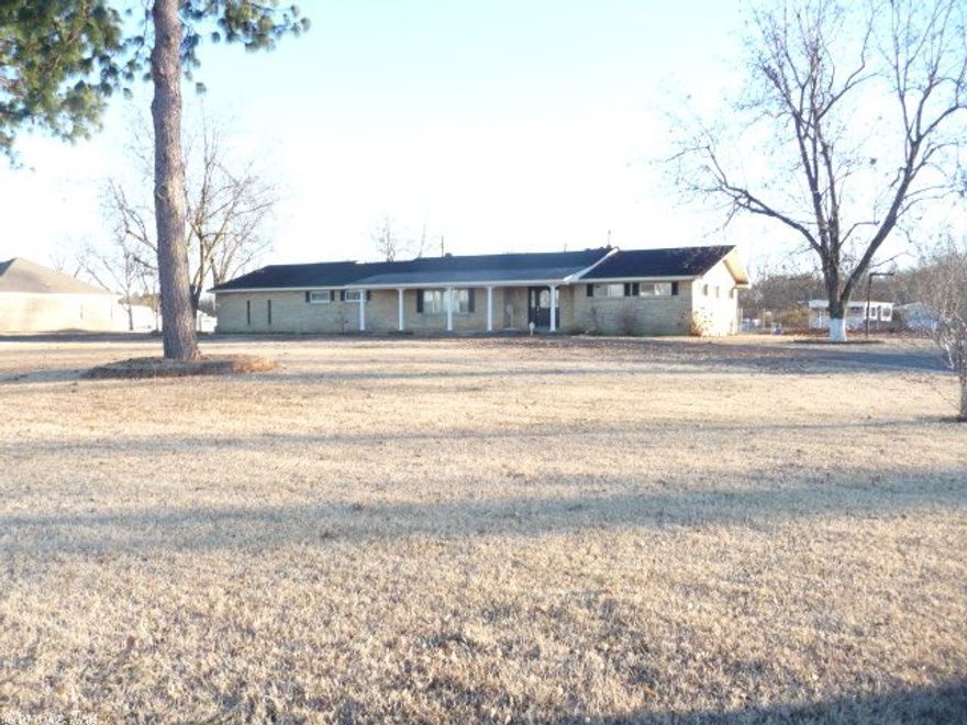 15 min. from downtown.  The home is well built but needs TLC.  It will need a new roof soon. The 2 acres are flat & beautiful with large pecan trees.  The pool is large & has a new liner installed summer 2014.  There is a gazebo & a large  shop or pool house, as well as another large storage bldg.There are 14 outside faucets.  There is a well (the well pump will have to be replaced) for watering the yard & filling the pool. Backyard is fenced, and sectioned off for dogs. House is sold "AS IS".