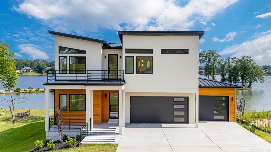 Luxury lakefront living on Lake Hamilton! This stunning 3 story home offers 5 spacious bedrooms, 5.1 bathrooms, and 100 feet of lake frontage with gorgeous, expansive views. High-end finishes flow throughout, including a gourmet kitchen with double ovens, gas range, large pantry, and abundant storage. Built-ins, oversized walk in closets, two laundry rooms (one upstairs and one downstairs), and thoughtful details are found in every room. Perfect for entertaining, this home is designed for both comfort and elegance. Conveniently located just minutes from Oaklawn, shopping, restaurants, and everything Hot Springs has to offer. A true must see! Call today to schedule your showing!