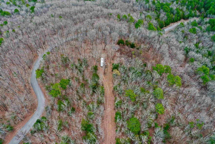 6.63 acres on a beautiful mountain with a view! This tract has water and electric established. No restrictions, mineral rights do not convey. There is a camper on the property that is negotiable with a separate bill of sale.