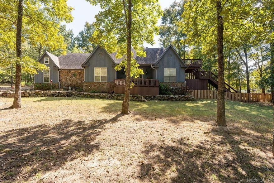 Sit back and enjoy lake views from the front porch of this stunning 4 bedroom, 3 full bath home located in an established neighborhood with its own private community airstrip! The gourmet kitchen features a FiveStar gas/electric freestanding commercial range and custom cabinetry with granite countertops. Bamboo flooring, exquisite crown molding and beautiful built-ins run throughout this home. Upstairs offers plenty of space for multiple beds, hidden storage behind every door, and a treetop deck with gorgeous views. The heated and cooled garage provides room for lake toys and gathering with friends. The backyard retreat contains an outdoor kitchen with multiple sitting areas on a covered deck so you can enjoy family time in your peaceful backyard. Neighborhood amenities include a private boat launch for easy access. View this custom home today before it is gone!