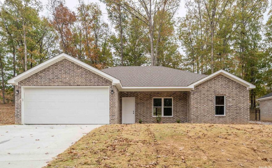 NEW CONSTRUCTION home in Diamondhead that backs up to a wooded area and golf fairway for privacy. The main living areas and bathrooms feature luxury vinyl flooring, and the kitchen is a chef's dream with granite countertops, stainless appliances, and custom cabinetry. The beauty of the outdoors is brought inside with numerous windows. This home is within walking distance of the pool, clubhouse, and many other great features of Diamondhead.