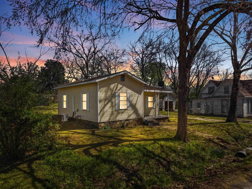 Charming home in the heart of downtown Morrilton! This 2 bedroom, 1 bath property is all electric with energy-efficient mini split systems to ensure year around comfort. Interior features include a blend of vinyl flooring and carpet, ample storage, and a spacious backyard. The refrigerator, washer, and dryer, and exterior storage building convey. This home is an excellent opportunity for a first-time buyer or investor. Schedule your showing today!