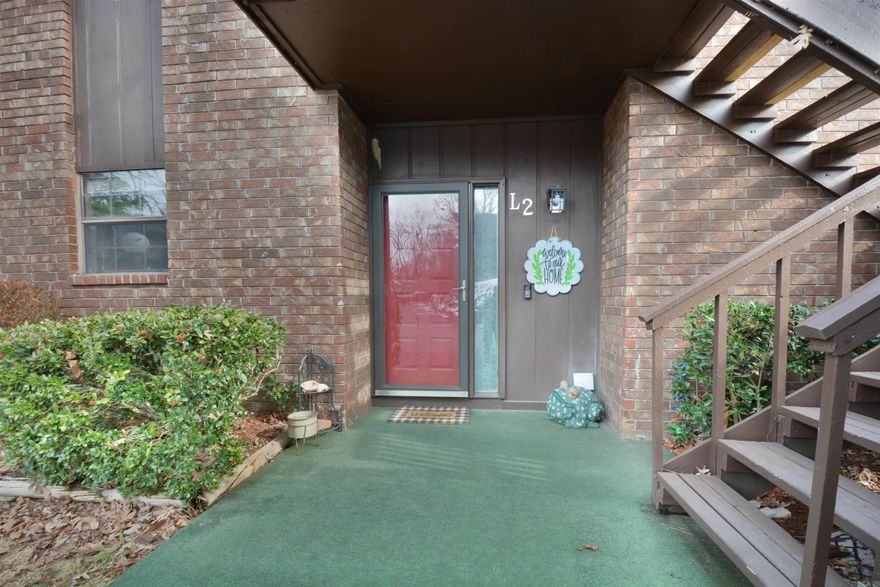 Beautifully updated GROUND LEVEL Lake Hamilton condo with covered parking right at your front door. This updated condo has hardwood flooring throughout, smooth ceilings with LED lighting, wood burning fireplace, wet bar, granite counter tops, stainless steel appliances, primary bath with 2 sinks, large tiled  shower with dual controls, Primary bedroom features 2 walk in closets, also updated guest bath.   Large outdoor living space on the deck that runs the entire length of the condo. Separate dining area has a dedicated balcony for grilling. 2 dedicated parking spaces (1- covered) right at your front door. Well kept quiet complex has a swimming pool and park like setting with quaint arched walking bridges. all to enjoy lake life at an affordable price!  No boat dock-- numberous available to rent.