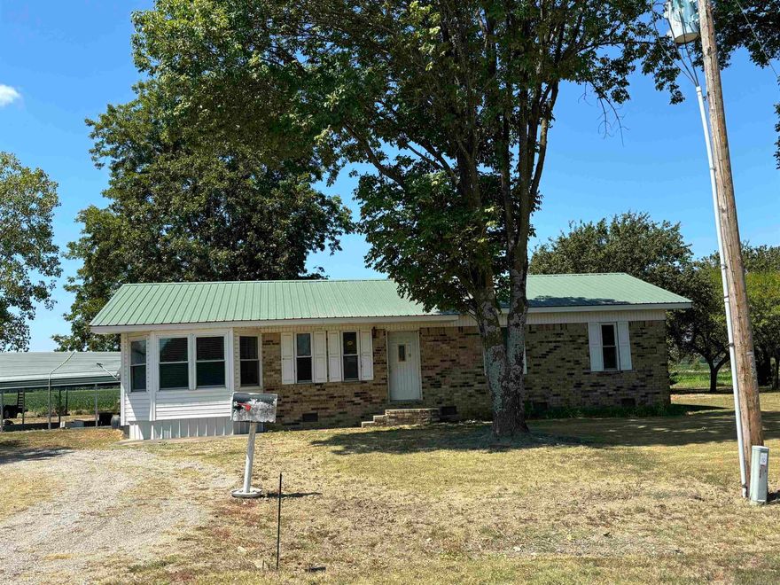 This country home sits 10 minutes east of Des Arc on 1 acre of land.  It is a 3 bedroom, 2 bath home with a large metal shop approx. 30x40 and an electric RV hookup.  Behind the house is a building that was used for an office and has a heating/air window unit. Enjoy the covered patio with flower gardens and a 2 car portable carport.  The yard has mature shade trees for country living at its best! This home would be perfect for a family, hunters or farmer.  White River is less than 10 minutes away and Interstate 40 is approx. 20 miles.