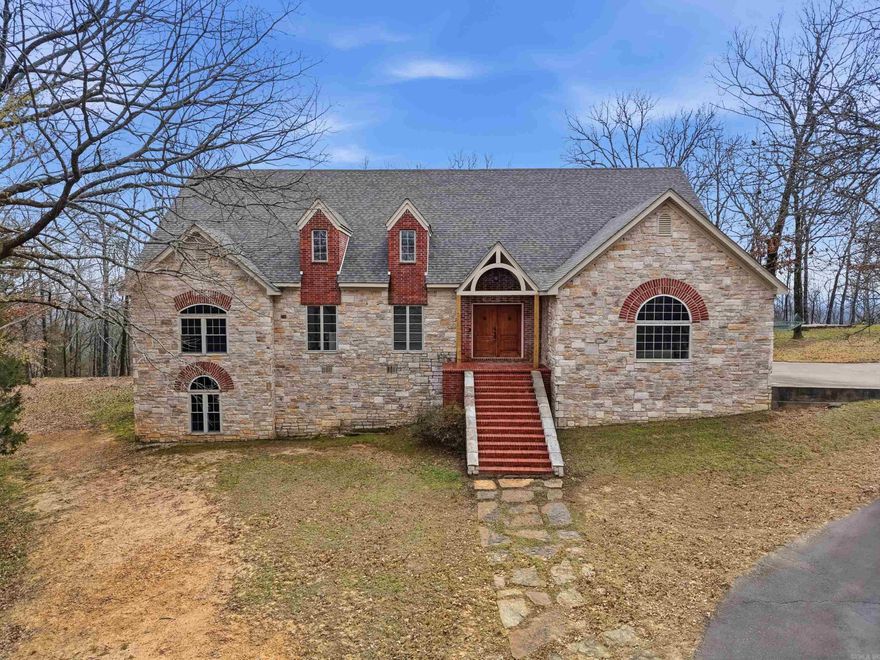 Private. Peaceful. Perfectly Located. Tucked away on 7 acres just 1 mile from I-40, this move-in ready home offers the best of both worlds: quiet country living and a quick 20-minute drive to Conway & 25 minutes to Russellville. This custom 4 bedroom, 4 bath home features soaring 14 ft ceilings in the living room & a stunning stone fireplace. Kitchen features quartz countertops, custom cabinetry & a spacious walk-in pantry. The main level is thoughtfully designed with 3 bedrooms, each featuring its own private ensuite bath, creating comfort and convenience for family and guests. The primary suite feels like a private retreat with its own fireplace, spa-style bath and dual walk-in closets. Large windows throughout the home flood the space with natural light, perfectly framing the peaceful wooded views and bringing the beauty of nature indoors. A walk-out basement adds an additional bedroom and bathroom with flexible space ideal for guests, game nights or a home theater. Relax on the oversized deck overlooking the trees and experience the privacy you’ve been searching for without giving up convenience. Homes like this don’t come along often. Schedule your private showing today.