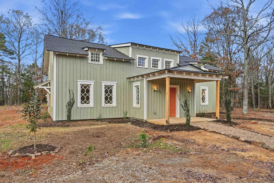 This recently remodeled home on 5 acres is one of the most unique, charming homes on the market! As soon as you enter the front porch and walk through the terracotta door, you'll know you've found something special. The charming details include 8x8 pine beams, native Arkansas pine tongue and groove floors, 100 year old windows from New England, and restored wooded doors from a turn of the century Boston tavern.  Nothing cookie-cutter here!  Downstairs you'll find a living room, large dining room, oversized pantry, beautiful kitchen with quartzite countertops and hickory cabinets , a full bath with clawfoot tub, a half bath, laundry room, and an office that could also be used as a 5th bedroom. Wainscoting walls add the perfect accent to the downstairs aesthetic. Upstairs is a large bonus room that could be used as a kid's play area, study, library, workout room, and more. All 4 bedrooms are upstairs, including an ensuite bathroom off the primary bedroom with custom tile shower. The other full bathroom also features a tile shower. This property is set up to be a homesteaders paradise with well water on site. The setting, the home, the details, are all stunning.
