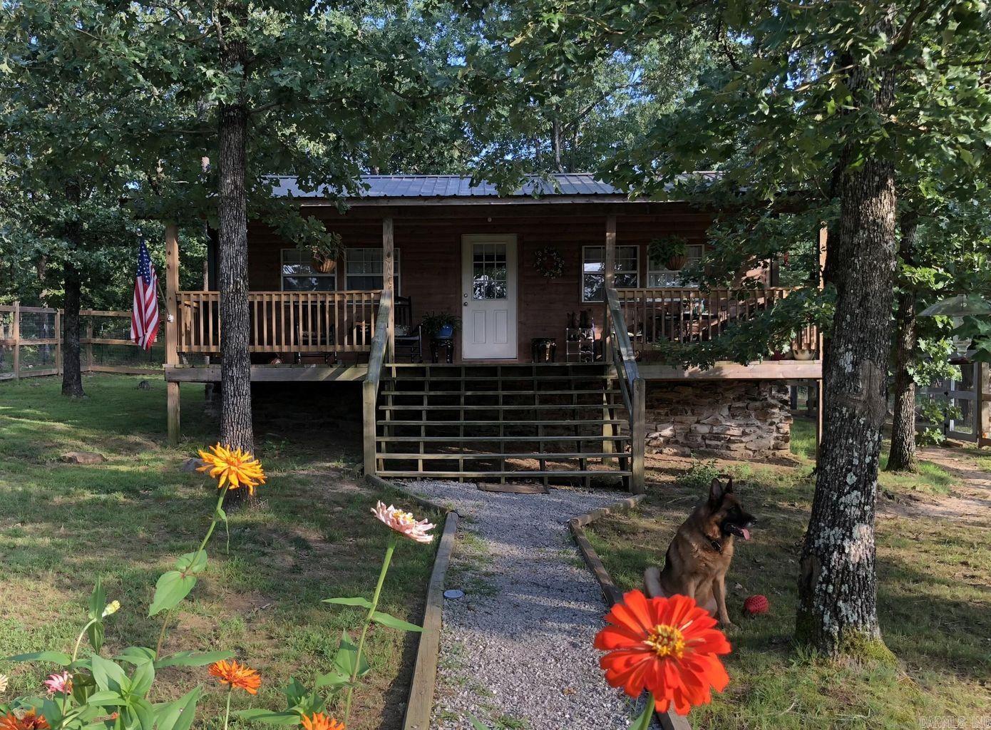 Thinking of going Tiny? Maybe looking for a 'Preppers Paradise' on 22.5 ACRES? This could be the one! This 2bd/1ba cozy cabin is ABSOLUTELY ADORABLE! (2nd bd currently used as office/laundry) Owner had High Speed Broadband as well. Kitchen/Living space is open/ample sized with a large standard sized fridge & stove and an eating bar w/storage. Land is fenced/cross fenced (plus tall fencing around home for even the most experienced escape artist fur-baby!) Small cattle pond toward back of property, and a nice fenced pasture toward the front of the property has a small stall/pole barn would be great for a horse or 2! Propane Tank is owned, tons of deer, garden spot, chicken coups, Bald Eagle Barn & fenced are behind home currently holding goats round out this little Gem of a property.