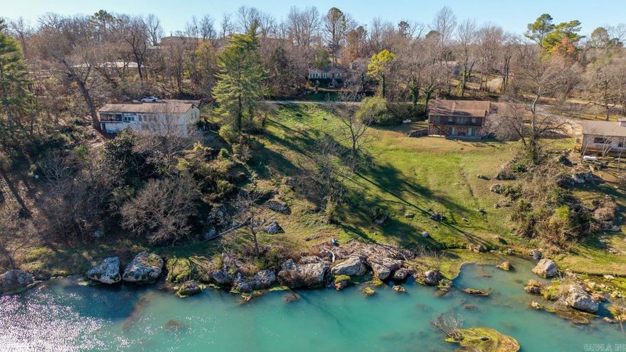 Riverfront Homesite on the Spring River  Discover just over half an acre of level, cleared, build-ready land in the heart of Mammoth Spring, Arkansas. With city water, sewer, and electric already at the lot line, you can start your dream build right away. This rare property offers 100+ feet of private Spring River frontage where you can fish, kayak, or simply step out your back door and enjoy the water every day.  You’re within walking distance of Mammoth Spring State Park, home to one of the largest natural springs in the country and the historic 1886 train depot museum. The Spring River is famous for trout fishing, smallmouth bass, and floating, making this location ideal for outdoor lovers.  Downtown shops and restaurants are less than five minutes away, with Walmart, medical clinics, and schools all within a 10-minute drive. For bigger shopping or entertainment, West Plains is 25 minutes north and Jonesboro about an hour south.  One of the last build-ready riverfront lots in town—secure this rare opportunity while it’s available. Contact us today to walk the property.