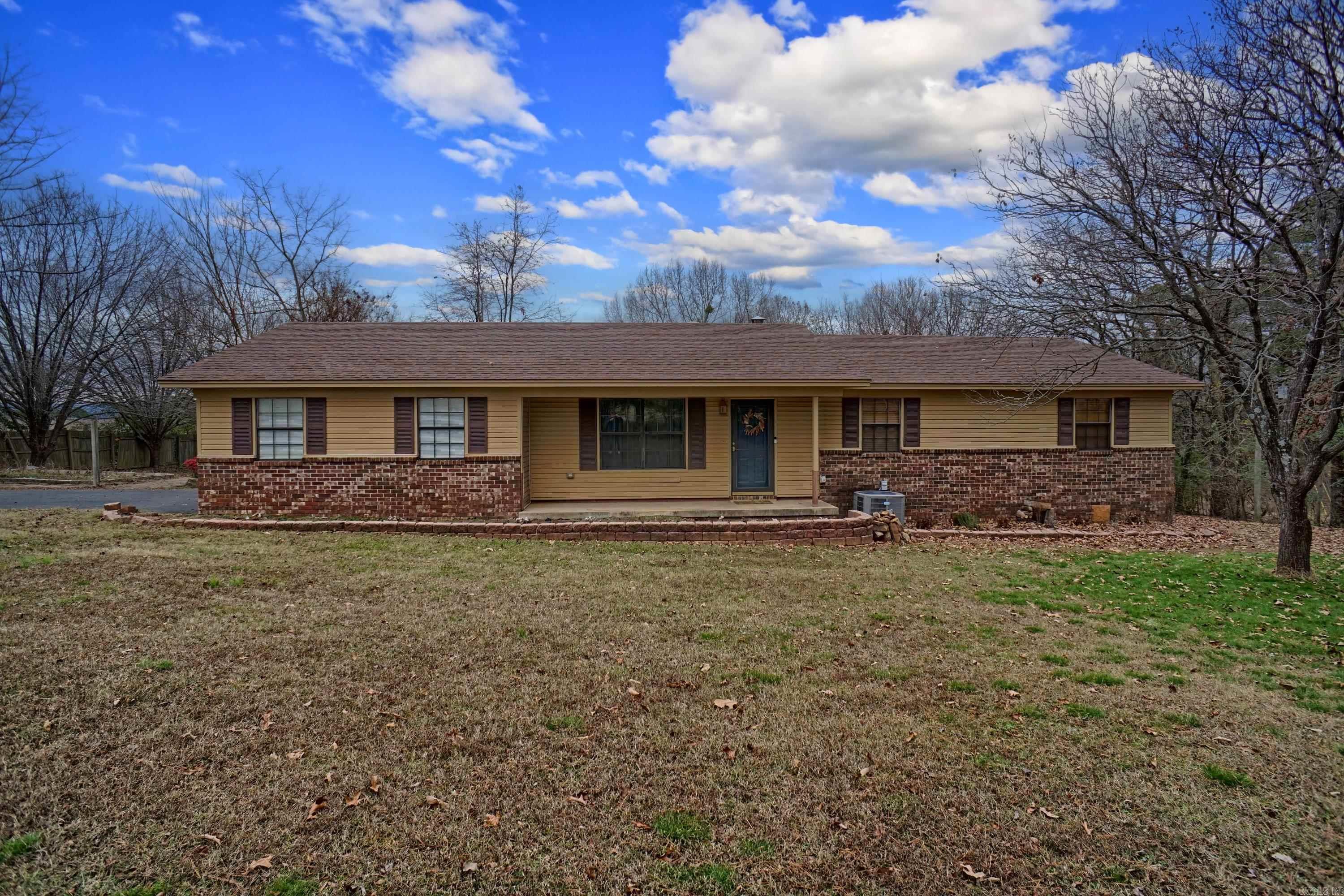 Embrace the perfect blend of tranquility and convenience with this charming 1,632 sq. ft. home, nestled on a serene one-acre lot in Clarksville, Arkansas. Featuring three spacious bedrooms, two full bathrooms, and a large dining room ideal for gatherings, this home is designed for both comfort and entertaining. The cozy living area, complete with a wood-burning fireplace, provides a welcoming retreat. While you’ll love the peaceful setting, you’re just minutes away from all the amenities Clarksville has to offer, including shopping, dining, and recreation. Don’t miss your chance to call this beautiful property home!