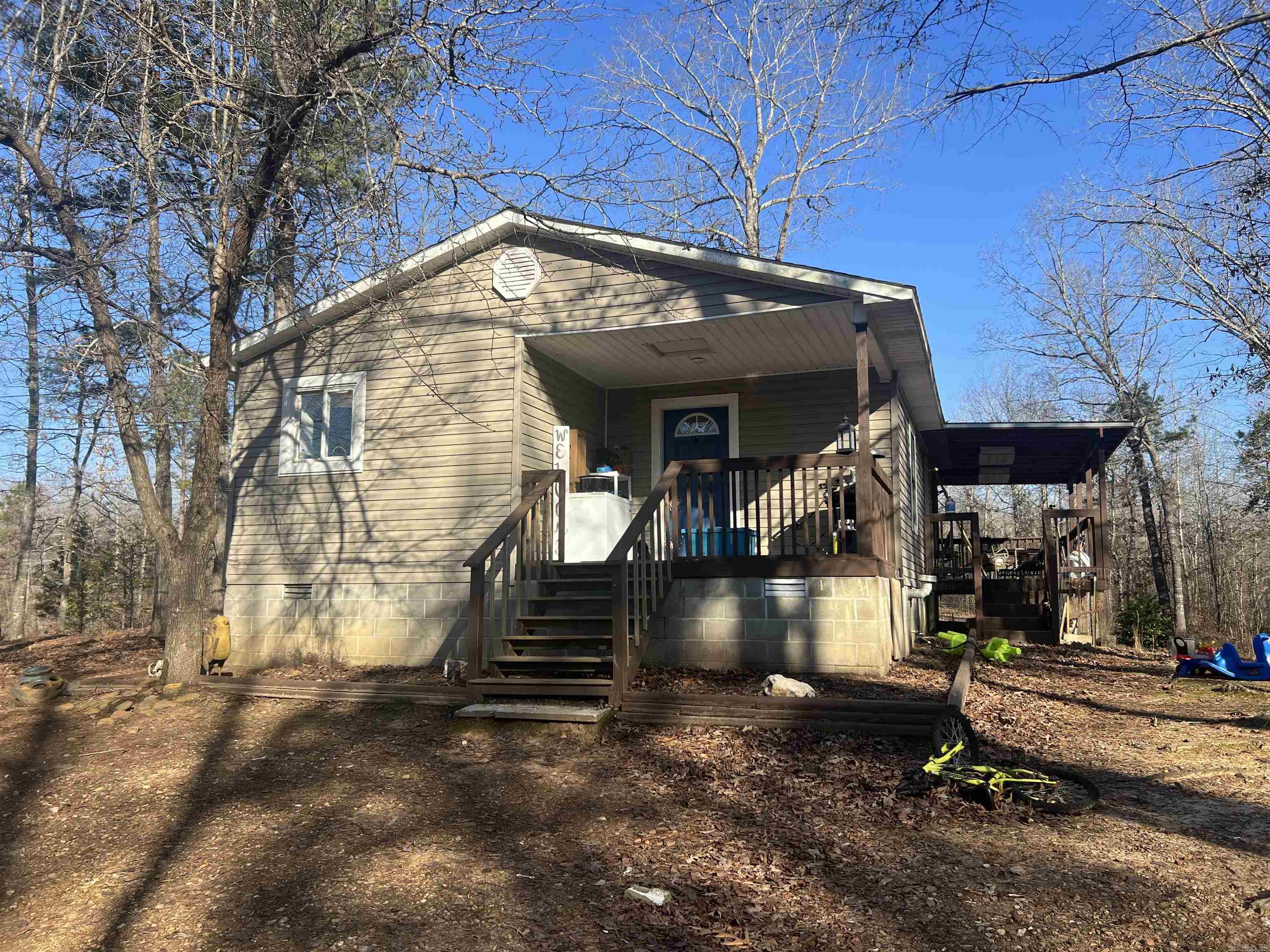 Great little starter home on approx. 1.55 acres. It has a front porch and a good size wrap around porch for grilling or just watching nature. This home has an open kitchen to living area. (the island in kitchen is negotiable) There is two large bedrooms with closets. No doors on the closets. There is another room that could be used as an office or bedroom but no closet. Lots of space to relax and no rules on animals. There is a small storage building and lien to off it for storage. Septic was pumped about 3 months ago. Newer paint, flooring in some rooms. New insulation. Please see remarks.