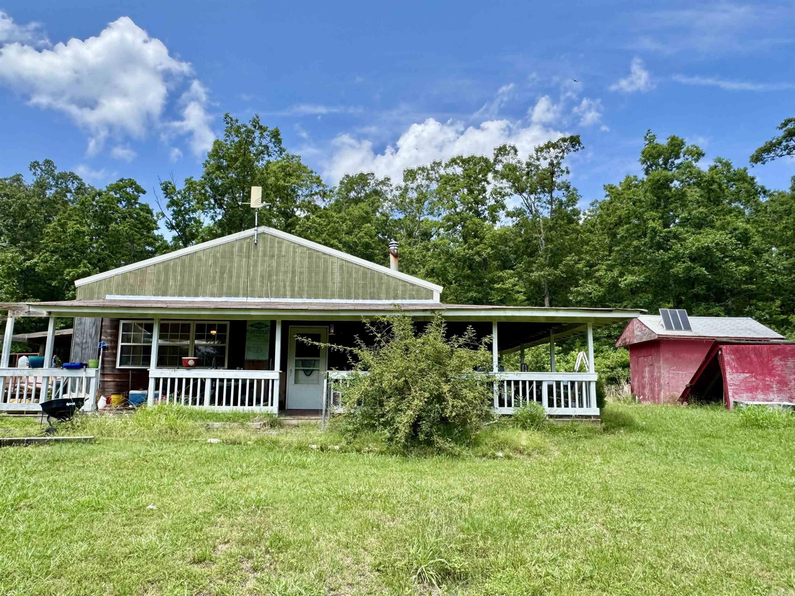 This 1-bedroom, 1-bathroom cabin is private and perfect for an outdoorsman, vacation property, or much more! The property includes 6.63 acres, and outdoor storage building, a nice big porch on the front and down one side of the house, a walk-in shower, and more. The cabin also has room for an addition, if someone wanted to build onto it and make it even bigger, it already has a spot cleared and leveled for an addition. It is just a short drive away from downtown Mountain View, and all of the local amenities. Which includes shopping, restaurants, a movie theater, Horseback riding, and multiple places to go listen to the world-famous Folk Music. Also, only a short drive away from The Ozark Folk Center State Park, Blanchard Springs Caverns, and the White River. Call today to set up an appointment, adventure awaits!