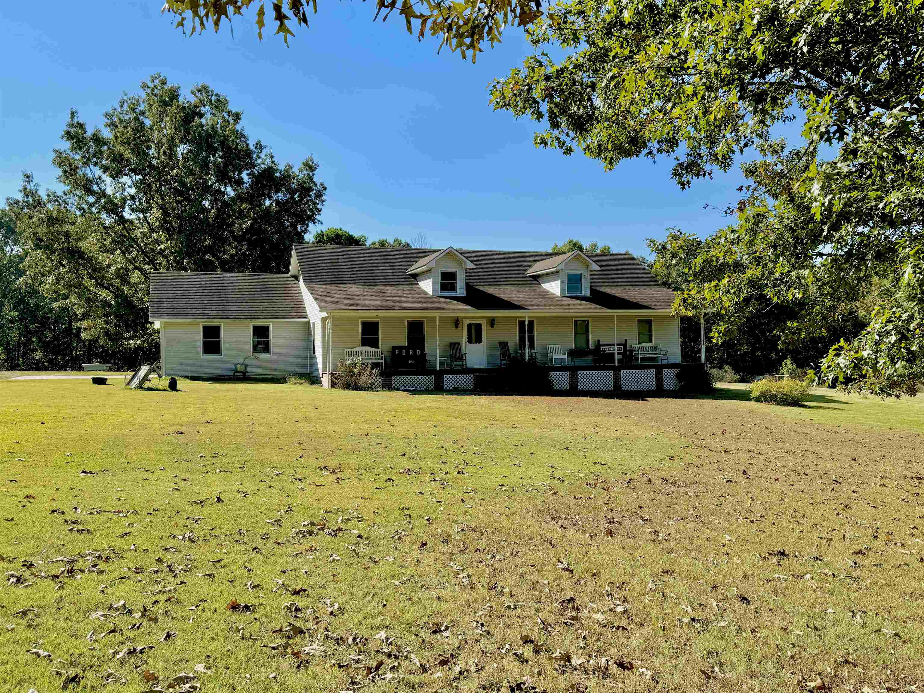 COUNTRY STYLE HOME & 47 ACRES! This home has a beautiful setting with a large front yard shaded with Oak Trees. The Home is a 3 bedroom, 2 bath home with a large living area and open kitchen/dining room! The master suite has a sitting area, full bathroom, and two closets. The home also has a screened in porch off the back, one vehicle garage, and one storage building. The property is mostly wooded, but does have a fenced in area for a hobby farm!