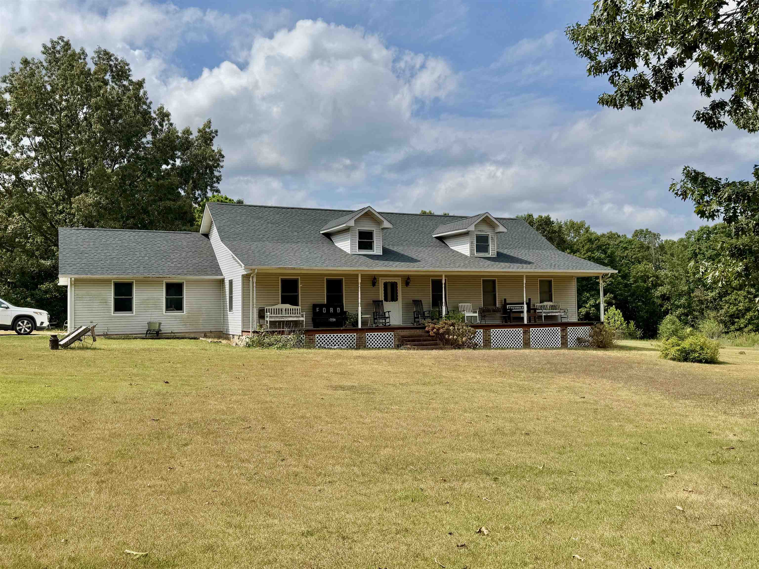 COUNTRY STYLE HOME & 42 ACRES! This home has a beautiful setting with a large front yard shaded with Oak Trees. The Home is a 3 bedroom, 2 bath home with a large living area and open kitchen/dining room! The master suite has a sitting area, full bathroom, and two closets. The home also has a screened in porch off the back, one vehicle garage, and one storage building. The property is mostly wooded and has a new roof installed in 2025!