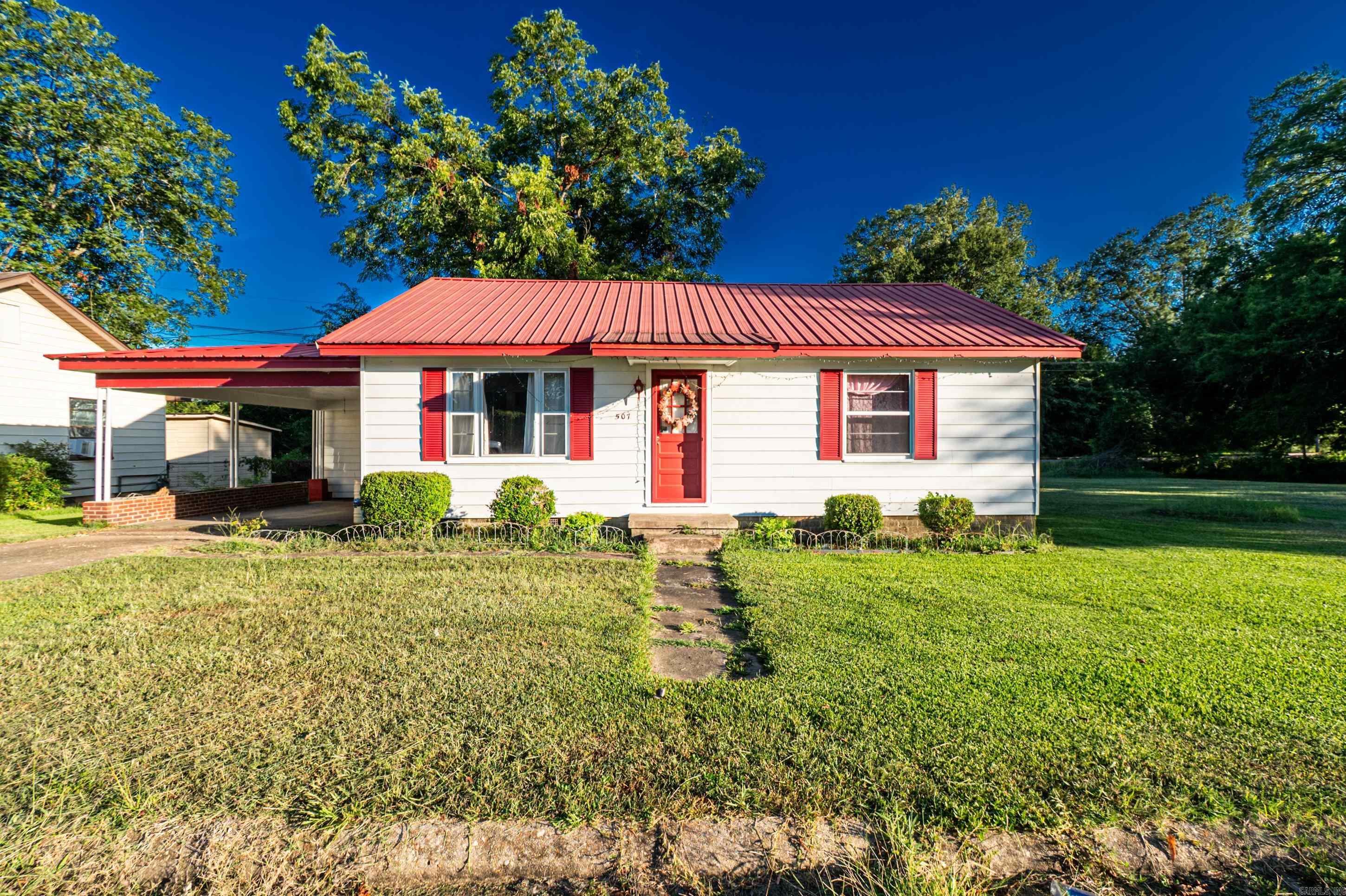 Charming 3-bedroom, 2 bath home offering a bright living room, cozy kitchen, and beautiful lot. With a convenient carport, storage shed, and privacy fence on part of the lot with small concrete pad - perfect for enjoying the outdoors. This house is located just walking distance from the City Park and minutes away from shopping areas. This home blends comfort and convenience perfectly!