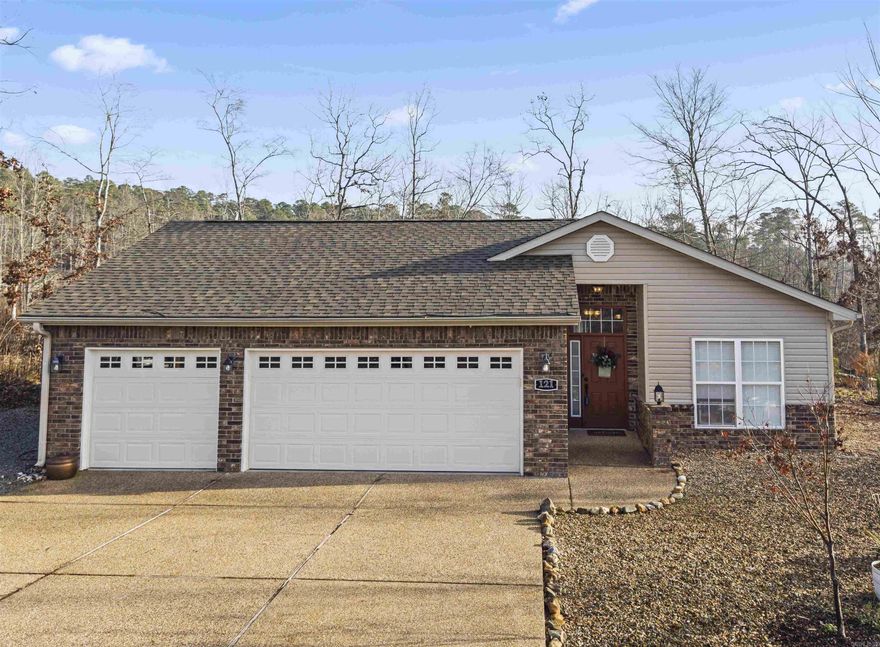 RARE FIND! Cute newer home (2008) with a 3 Car Garage under $300k! Gorgeous 2024 Kitchen remodel boasts New Counters & Backsplash (Dolomite Marble), 2024 New Pella Window over the Granite Kitchen Sink (opens to serve food to the patio), 2024 Double Oven (Conventional/Convection/Air Fryer)! Both Bathrooms also have been remodeled with Dolomite Marble Counters, New sinks, Faucets, and Knobs! The warming Electric Fireplace in the Living Room adds ambiance! Roof NEW in 2021/2024. Extra Insulation by Entergy for efficiency. Large storage shed next to the house for all your storage needs! 26,000 acre Hot Springs Village offers 11 Lakes & 9 Golf Courses, Tennis, Pickleball, Mini Golf, Fitness Center, Indoor & Outdoor Pools, Performing Arts Center, 20+ Miles of Walking/Biking Trails, 2 Marinas, 13+ Restaurants, 24 Churches and much more!