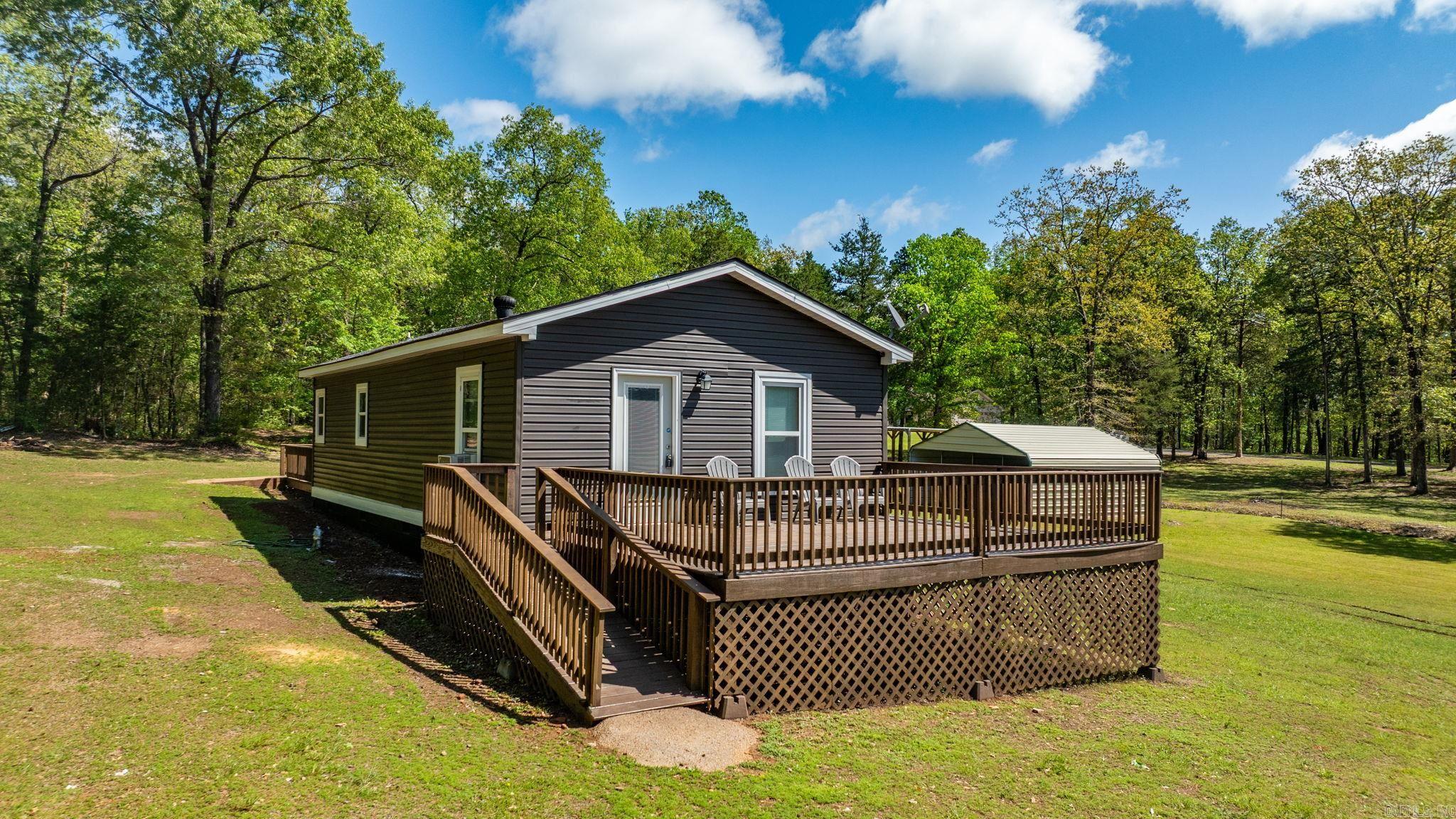 Welcome to the market 1381 HWY 330 in Choctaw!! 2 Bed, 1.5 Bath Home on approximately 3.04 Acres Near Greers Ferry Lake This home has about 814 square feet of living space and sits on 3.04+/- acres (see survey). It includes a large 24x35 carport and an RV hookup already in place. This property has no restrictions and move in ready!! All the work has been done for you! Located about 2.7 miles from Choctaw Marina and approximately 0.3 miles from Greers Ferry Lake, it's a great spot for a full-time home, rental, or weekend getaway. Plenty of space to build another cabin or bring your ideas to life!