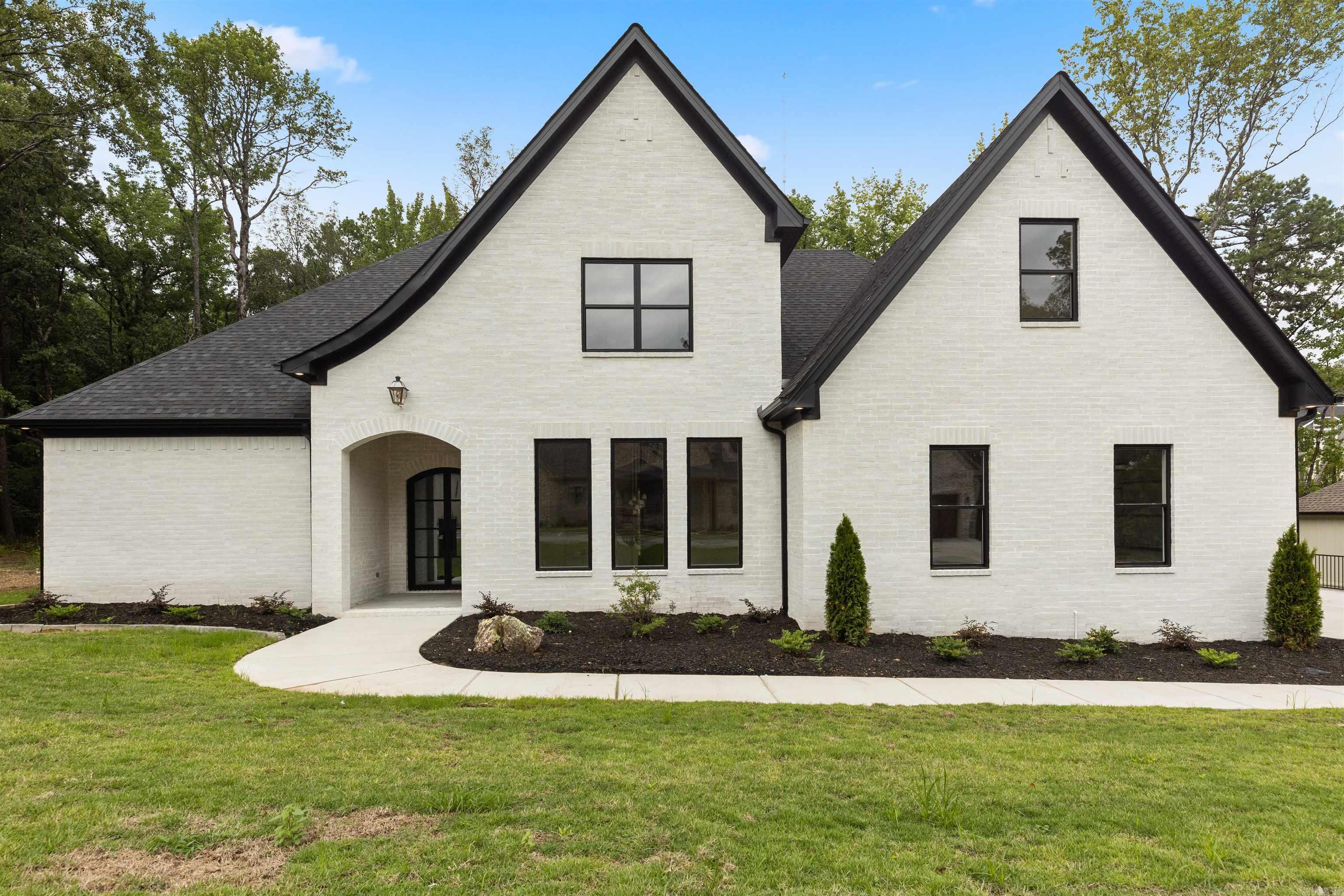 Welcome home to Bear Den Estates, West Little Rock's newest destination for luxury living! This foliage rich community offers residents protected greenspace areas, miles of hiking/multi-use trail systems, a community park with playground, wildlife observation areas, and Bear Den Mountain Preserve. This custom home is meticulously designed to cater to your every need. Enjoy a stellar layout with two owner suites on the main level, one of which has its own attached sunroom equipped with a fireplace to enjoy the protected greenspace views that surround you. The main primary suite also features a spa-like oasis bath with a custom closet that dreams are made of! Your new home is perfect for entertaining with a formal dining area that features a dry bar for serving as well as an open concept kitchen, great room, and breakfast area. The designated office nook off of the breakfast area is the perfect spot for your home office or a homework station depending on your lifestyle needs. Enjoy designer curated finishes & an attention to detail that you deserve in your next home! This home is truly a standout and magazine worthy!