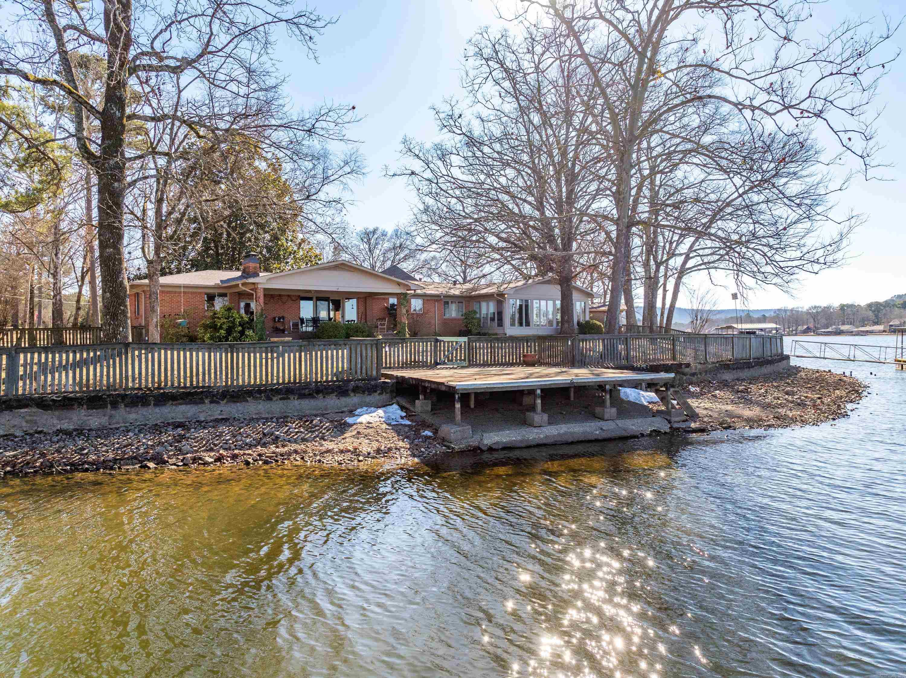 This Lakefront home at 295 Caroline Acres Road has the lake and mountain views you've been looking for. This 4 Bedroom 3 Bath home located in the much sought after Caroline Acres subdivision is ready for its new owner. The open floorplan features a kitchen living combination with a woodburning fireplace for those cozy nights at home. There is a wonderful glass enclosed sunroom to spend hours gazing at the gorgeous views. Just steps from your own private boat dock and swim dock with over 280 linear lake footage this home is the perfect place for lakefront entertaining.