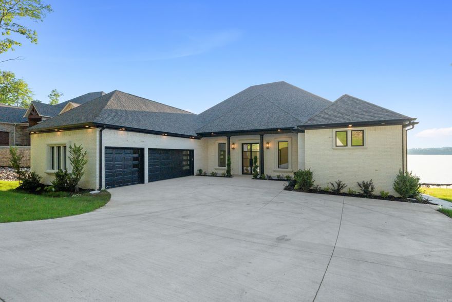 This home checks all the boxes: New Construction on Lake Hamilton, Deep Water and Expansive views, Highly Desired 7 South location and a Stunning Home with the appointments you are looking for. Beautiful wood ceilings and beams add charm to this open floorplan home that welcomes your family and guests.  Large granite island in the chef’s kitchen, with custom cabinets throughout.  Four fireplaces add to the warmth and coziness of this lakeside retreat. The primary bedroom features a vaulted wood ceiling, fireplace, and private coffee bar. Custom His and Her closets with plenty of storage and built ins. The primary ensuite has a luxurious Roman Double Shower and his and hers vanities and a soaking tub. All bedrooms in the home are ensuite. The outdoor living area is covered and has a fantastic outdoor kitchen. This home has a boat dock . POA is currently being formed, no financial or dues amount have been established but developer had indicated it should be like Blue Herron POA.