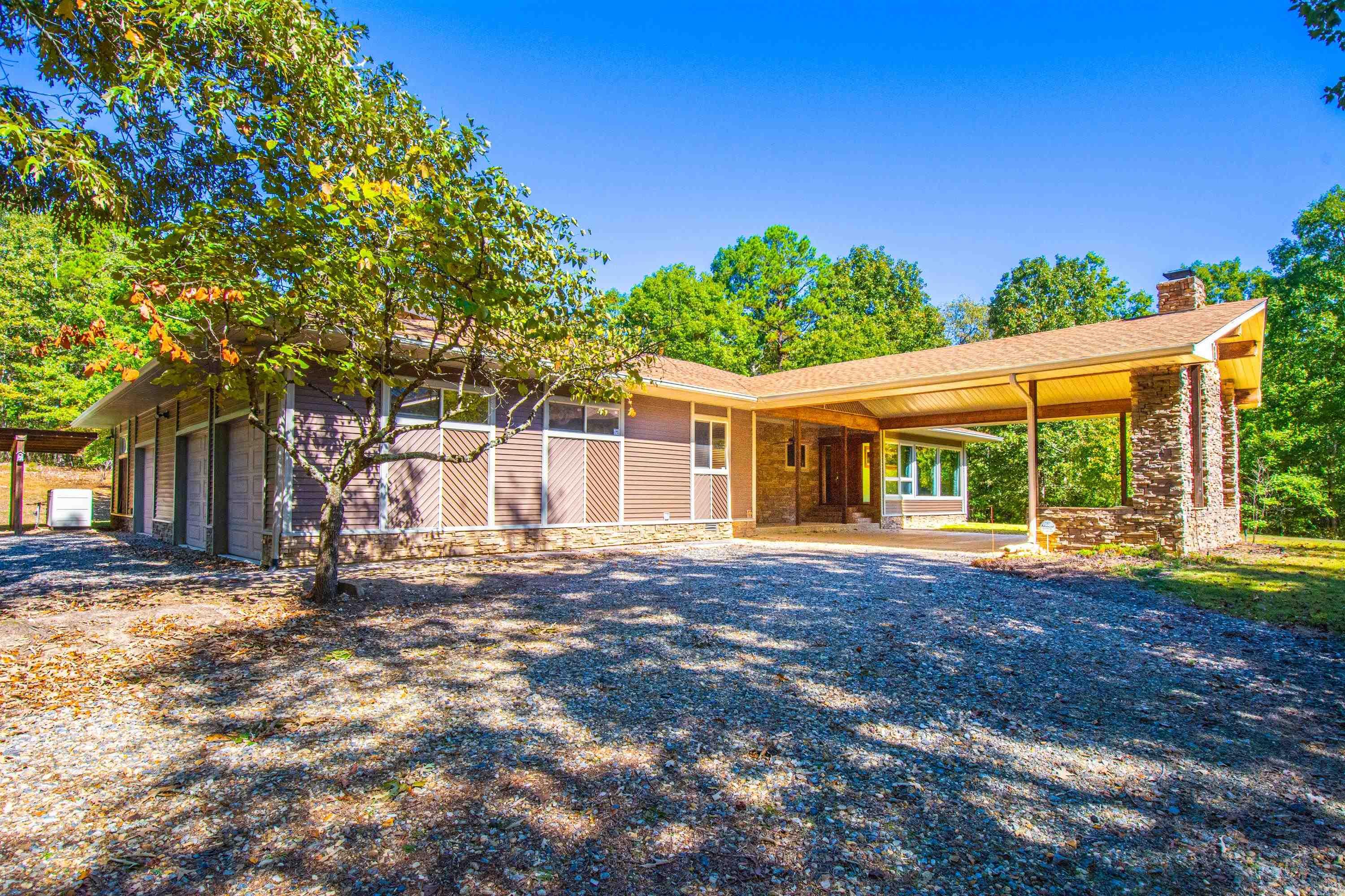 Discover a peaceful retreat nestled on 40 forested acres, where a handsome 3-bedroom, 2.5-bathroom home awaits. Created by a woodworking craftsman, this residence showcases exquisite details in the wood floors, kitchen cabinets, and trim work. Entertain in the open concept living area, complemented by a gourmet kitchen featuring stainless steel appliances, granite countertops and a spacious island. Two woodburning fireplaces, one in the great room and one on the carport/patio. Enjoy the sunporch for moments of relaxation. This home offers a three-car garage, with the workshop side both heated and cooled, as well as three covered parking pads. Additional features include a Cummins Generator and a whole house water filtration system. Recent upgrades include a new roof in 2023 and a new water heater in 2021.