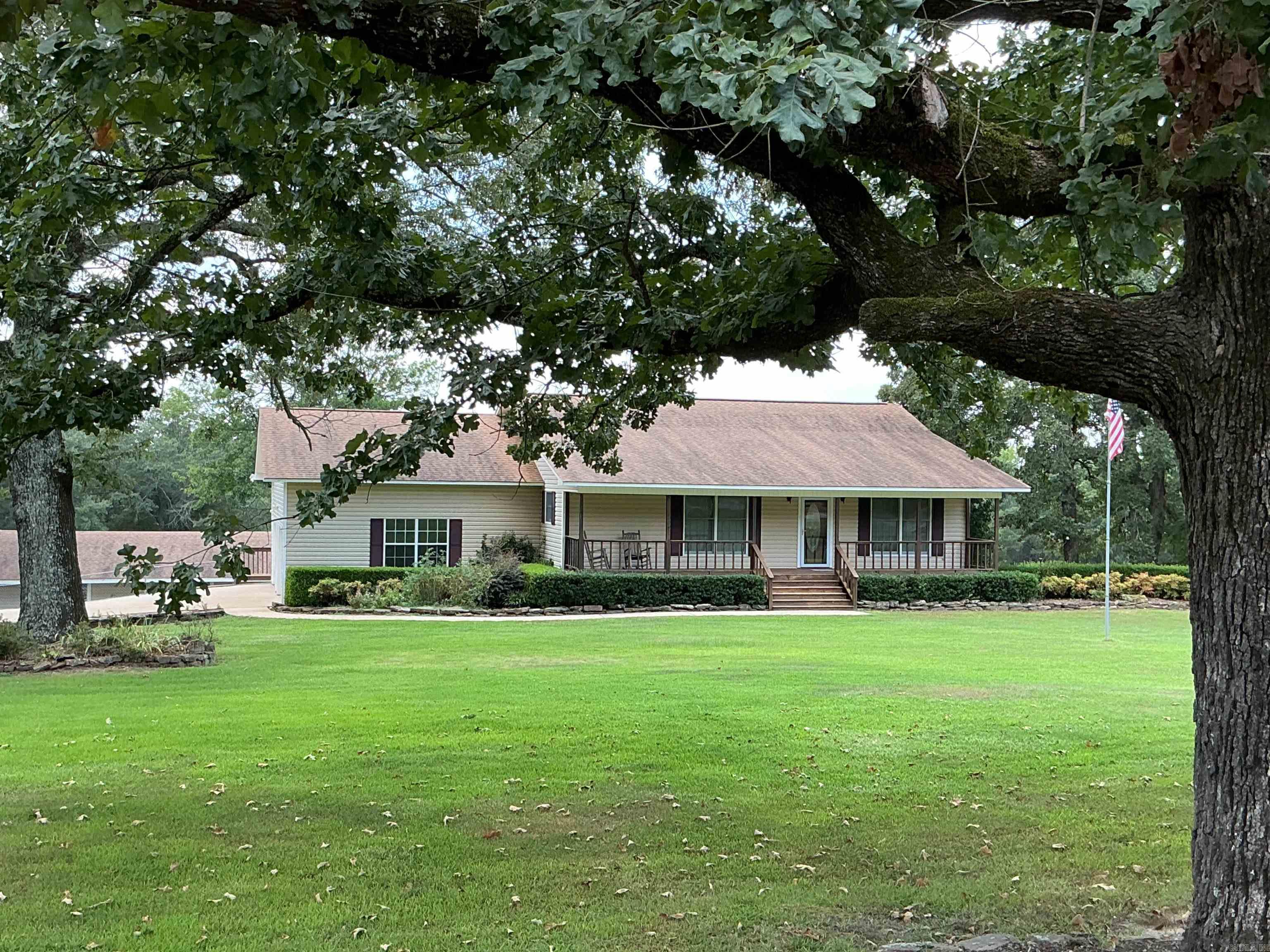 Beautiful Lakefront Country Home with Boat slip on 2.43 acres Wow this place has so much to offer with plenty of room outside and inside! Home is 3 beds, 3 baths, spacious rooms, lots of windows in open Kitchen, dining, living room with corner gas log Oak fireplace and Tray ceiling, walk out to 16 x 28 covered deck. Full finished basement with lots of storage and sleeping areas. 2 baths up and 1 down. New Roof and Heat and air replaced in 2018 and has a dehumidifier built in. New floors in basement and new paint all through home, Stairlift was replaced with new one last year. Central Vac system throughout! Outside has attached 2 car garage, shop building with rollup door, electric, water, old bathroom, plenty of storage and lean-to on side. 2 carports for camper, boats or vehicles. 1 Boat slip in a 5 stall boat dock. Gentle walk to the water.