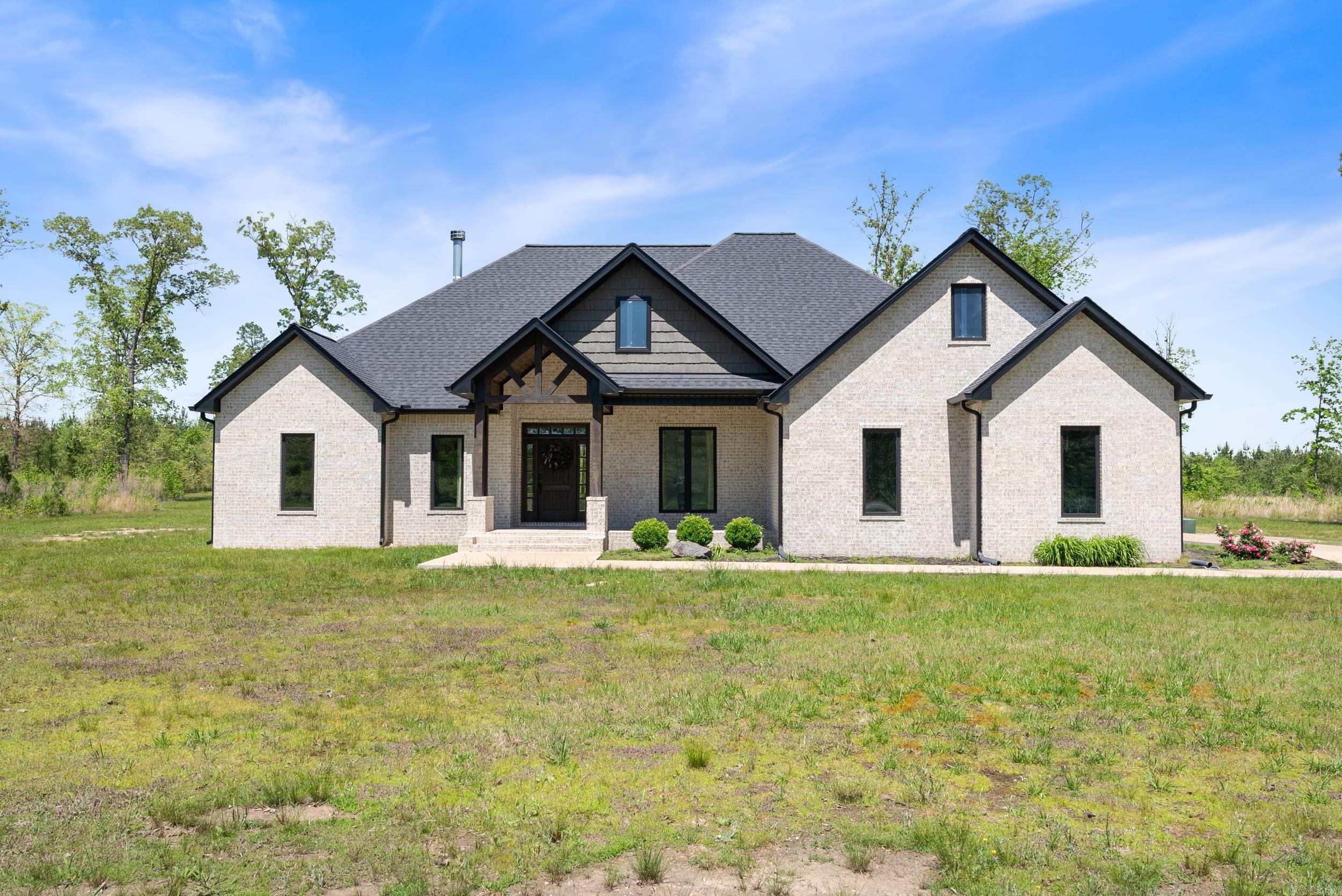 This beautiful custom home sits on just over 17 acres of land. This home is approx 2800 sq ft, and features 4 bedrooms, 2.5 bathrooms, and an office. Inside it has a wonderful open floor plan, with a beautiful wood burning fireplace in the living room. The kitchen has a gas cooktop, double ovens, granite countertops, an oversized island, and a large pantry. The primary suite has a walk in closet that you can access off the bath or by walking through the laundry area. The closet also has a center island wardrobe. Downstairs there’s 3 bedrooms, and a dedicated office space. Upstairs there is a bonus room. Outside you will find a spacious back porch with another wood burning fireplace. In the back yard there is a fenced in area, with a building that was used as a dog kennel. This home is wired for a generator, has spray foam insulation, a gas tankless hot water heater, and gas heat.