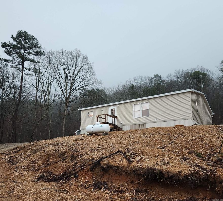 Home & cabin (currently used as a rental) on 4 wooded acres with a storm shelter.