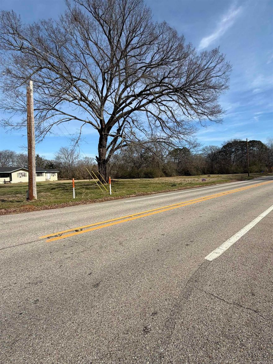 This small commercial lot is located right on the edge of town near a well-traveled intersection, making it a solid spot for a local business or investment. With steady traffic passing by each day, it offers good visibility without the congestion of being right downtown.