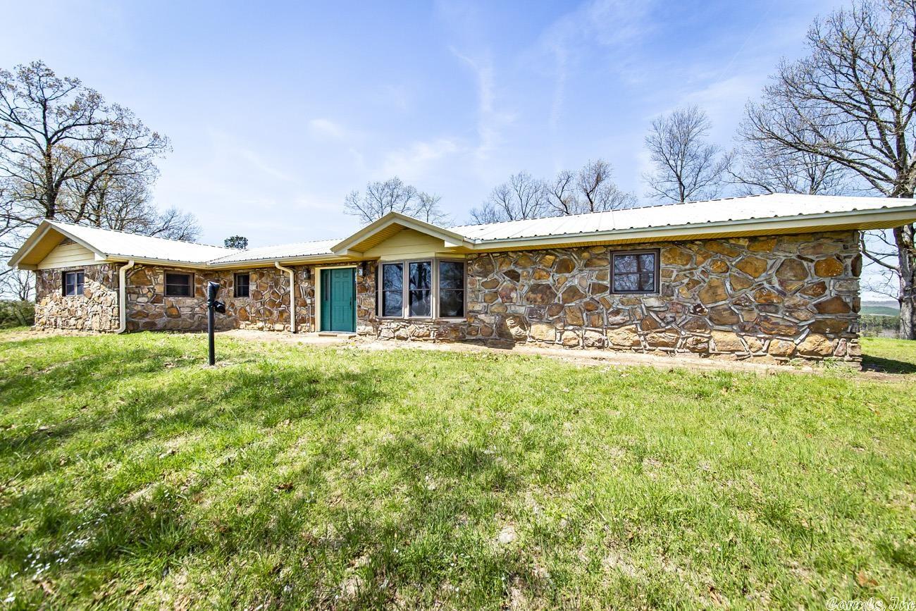 Set in the foothills of the Ozark Mtns is one the of the few remaining farms of this size. Spectacular views of rolling pasture & mountains. A combination of open pasture to wooded land, creek & 4 ponds make it the ideal property for the buyer looking for both recreational & grazing/agricultural potential. This farm features several barns & a native rock farmhouse. Remodeled in 2017 the home has new h/a, windows, metal roof, dual pantries, cabinets, quartz countertops & so much more.