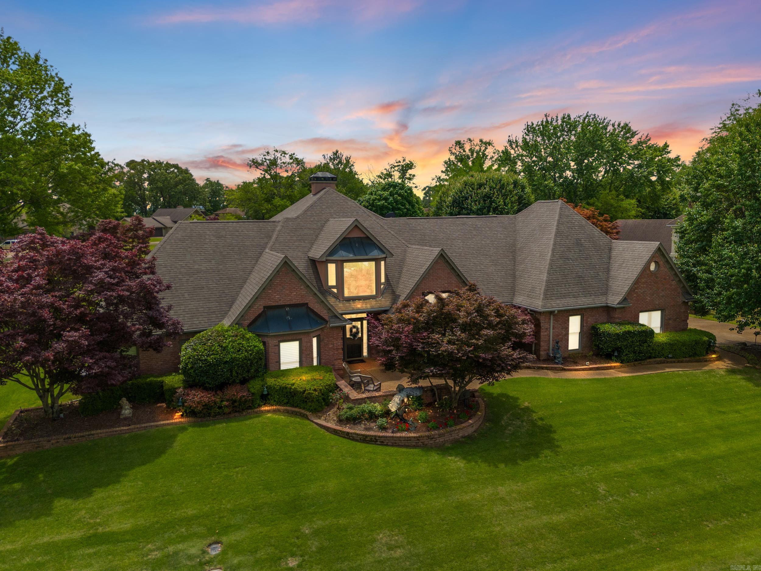 Experience refined luxury in Eden Isle’s most exclusive offering! Panoramic views of Greer's Ferry Lake accessible by the private Marina and a golf course backdrop, This custom-built home blends timeless elegance with high-end finishes throughout. The main level features custom hardwoods, a spacious living room, a formal dining, library, and a gourmet kitchen with Travertine Tile, Italian 2" Limestone counters, KitchenAid appliances, Nugget IceMaker and more. The oversized primary suite boasts a spa-like bath with jacuzzi, shower, and dual sinks and dual closets. Two En-suite bedrooms are downstairs, while the upper level includes a Spacious Den with fireplace, entertaining bar/kitchen, Outdoor Balcony, 4th bedroom/office, and an additional Bonus area ideal for that home theater already equipped with surround sound. Finish the day with your own private outdoor sanctuary—an expansive covered porch perfectly positioned to capture sweeping golf course views, ideal for year-round relaxation and enjoyment. Extras: whole-home generator, storm shelter, plantation shutters, 3-car garage, and alarm system. Every detail reflects a lifestyle of comfort and sophistication- Inside and Out!