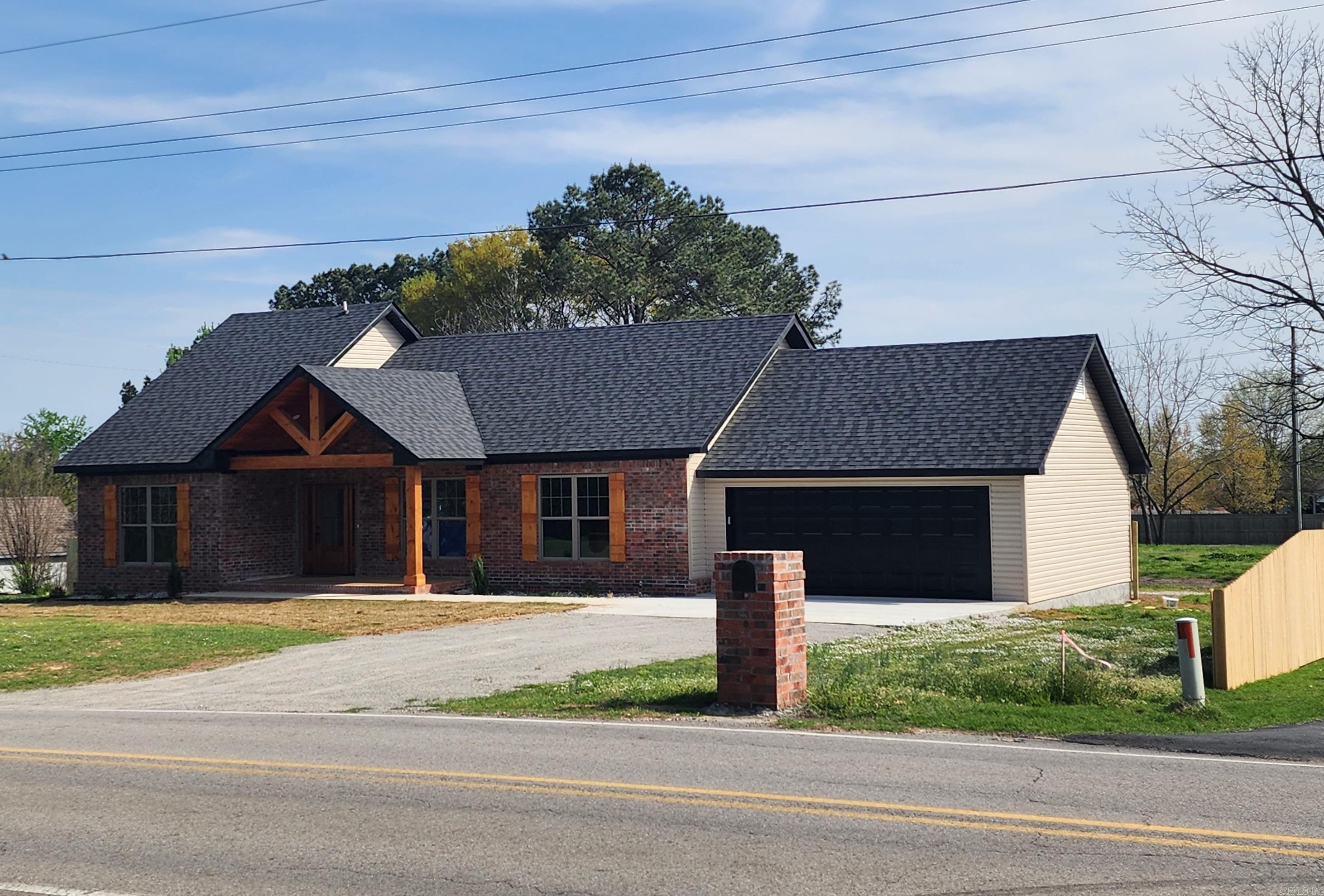 This 1,074 sq ft house built in 1951 was recently transformed & added onto with over 90% down to the studs being NEW! NEW ADD-ONS include a 4th bedroom or bonus room upstairs, main bedroom with attached bath & a 2 car garage added. NEW ROOF, NEW VINYL PLANK FLOORING, NEW VINYL WINDOWS, NEW BRICK, VINYL & TRIM, NEW CABINETS, NEW GRAINITE COUNTERTOPS, NEW HVAC, ALL NEW INTERIOR PLUMBING, ALL NEW ELECTRIC, NEW STAINLESS APPLIANCES INCLUDING REFRIGERATOR, NEW STAINED WOOD BEAMS & TOUNGE & GROOVE CEILINGS ON PORCH. VALTED LIVING ROOM, KITCHED & MAIN BATH. NEW PRIVACY FENCE SINCE LISTED. Located in SW Searcy just across the street from Searcy city limits. See agent remarks!