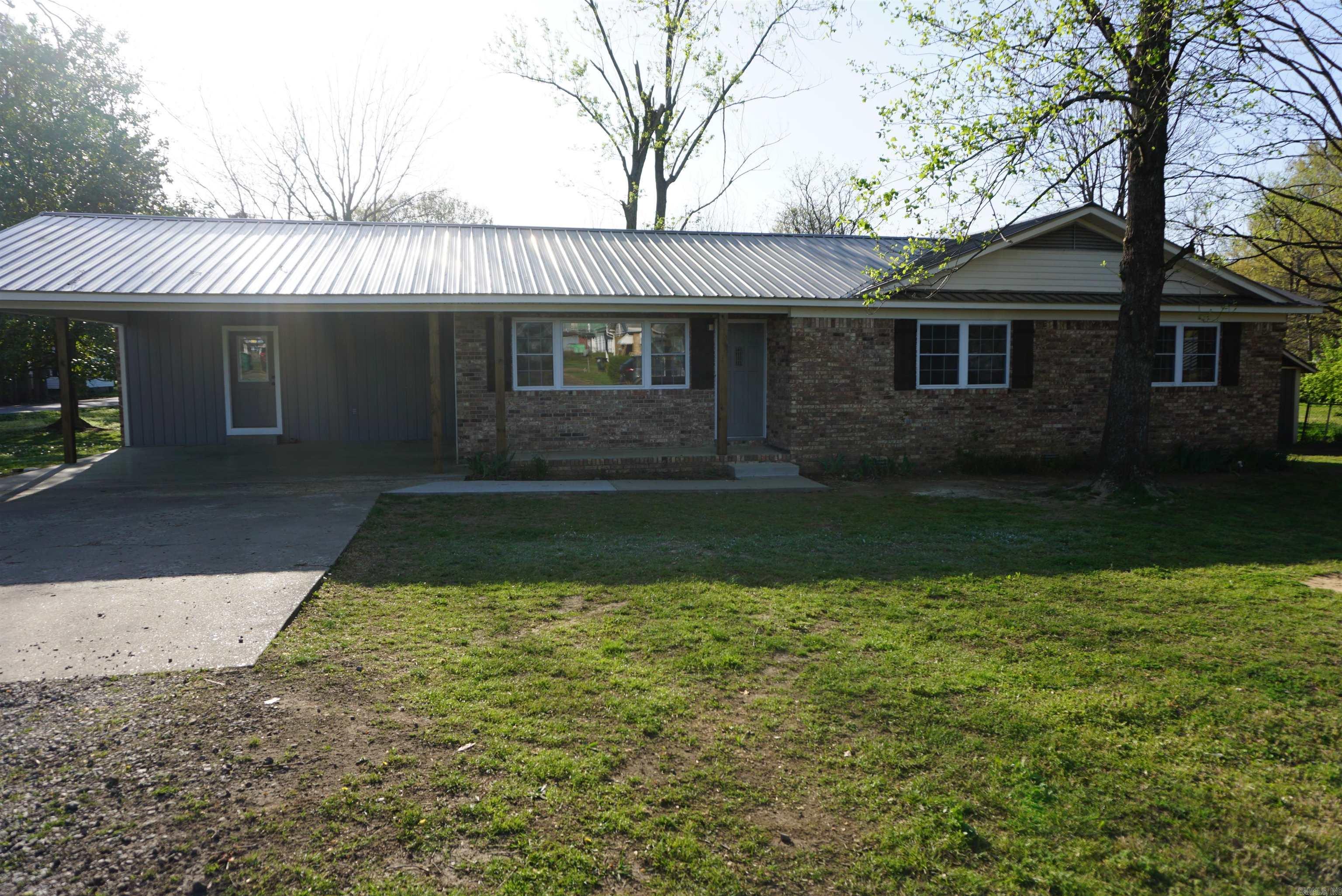 Very pretty remodel with all new painting, new flooring, new countertops, new light fixtures, and so much more. Electrical and plumbing have both been gone through and updated and are up to city code. The kitchen has tons of cabinets in the kitchen plus all new appliances and an amazing walk in pantry. Large laundry room with built in cabinets located in the entry from the carport and flows into the kitchen. So many pretty windows throughout brings in so much natural light. Bedrooms are all great size and have nice closets. The main bathroom and primary both have very deep tubs and have extra tall showers with hand held shower heads. This yard is fenced on 2 sides and has so much space in the back yard plus there is a huge shop in the back yard and another storage building for even more storage. Seller is offering a $500 home warranty with acceptable offer. Dont miss the front door and it's super cool unique feature. I love it.