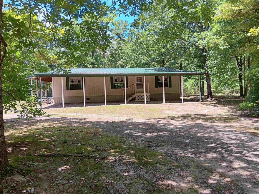 WOW!!!! 3 bedroom 2 bath modular home sitting on 4 acres in the middle of Greers Ferry. Home has new floors thru out and new kitchen cabinets. Large deck on back of house for entertaining . Small shop and storage building in back of yard. Fish cleaning area also!! Lots of trees make this property very private. Xtra power pole ,  water and septic available for possible additional home.