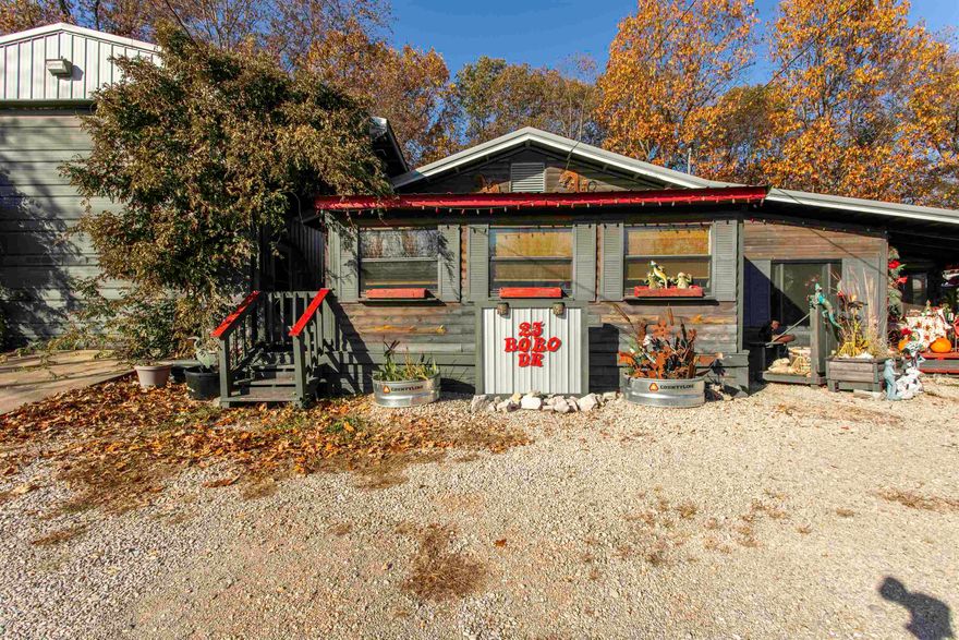 Discover a truly unique property in Hardy, Arkansas—ideal for a Spring River getaway, Airbnb investment, or live-work retreat. Offering 4 bedrooms, 2 baths, and 2,765 sq ft of heated and cooled space, this versatile compound provides multiple living areas connected by covered walkways. The main home features log siding, an open kitchen-to-living layout, a spacious bedroom, and a large screened-in porch. A 25x45 insulated RV garage includes 14’ doors, bath, laundry, and heat as well as mini split, with a 40’ converted storage container attached as a bedroom with sitting area. Another shop building includes a wood-burning stove, and a Bald Eagle-style barn has also been converted into a bedroom. A second large shipping container near the front serves as an additional bedroom and lounge. Outdoor features include two electrical services, RV parking with 30-amp hookup, a fenced yard, fire pit, and multiple flex buildings for storage, hobbies, or expansion. Perfect for buyers seeking a distinctive property with space, privacy, and income-producing potential.