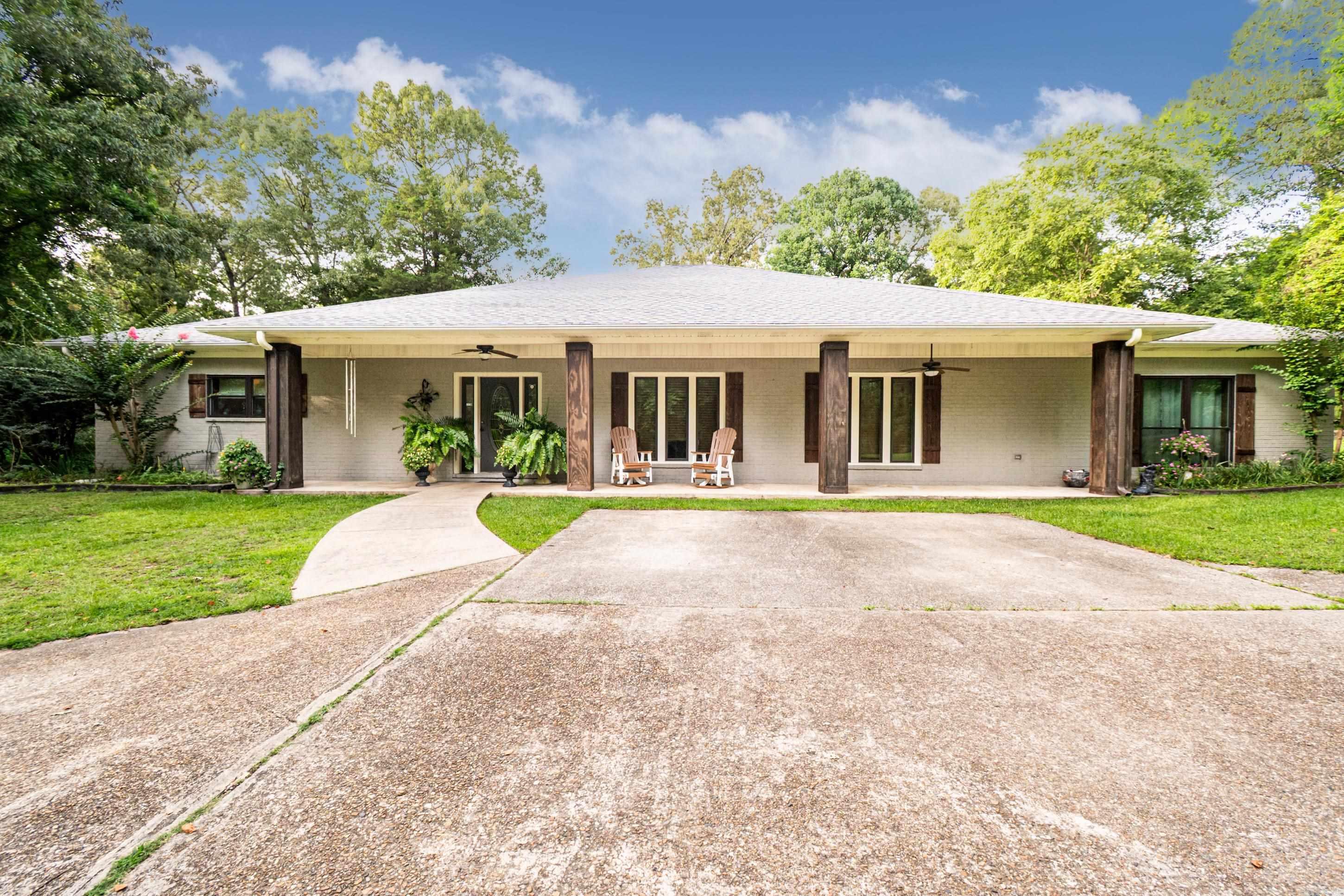 Enjoy peaceful country living just outside of town with this charming 3-bedroom, 3.5-bath traditional home situated on 21.66 acres. Built in 1998, the home features a spacious layout with granite countertops in the kitchen and multiple living and entertaining areas. Step outside to your own private retreat—complete with an in-ground pool (new liner in 2023), pool house, and a serene pond. A 36x57 shop with plumbing and a half bath adds flexibility for storage, hobbies, or workspace. Please note: the chandelier in the family room and the deer house by the pond do not remain with the property. This rare property combines comfort, space, and natural beauty—perfect for those seeking a bit of everything in a quiet setting.