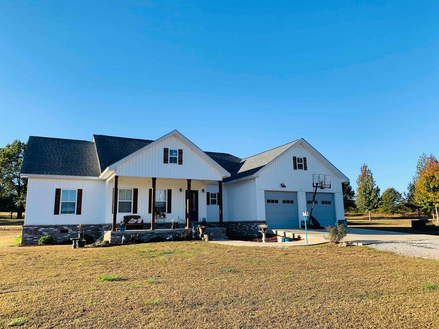 This charming, farmhouse-style home in rural Arkansas is a dream! A covered porch in the front and back is the ideal spot to savor the pastoral scenes of  that quiet countryside you’ve always longed for. Inside, you will appreciate the gas log fireplace in the spacious living room for those nippy Arkansas winters. A quick breakfast or a lazy weekend brunch can be enjoyed on the kitchen island/breakfast bar with butcher block countertop. The main bedroom boasts an astoundingly large bathroom filled with goodies - his and her granite countertop sinks, a freestanding tub if you love to luxuriate in a nice, warm bath, a walk-in shower, and a walk-in closet. What more can you ask for?  Just minutes away from schools, clinics, grocery stores, and a top notch public golf course, this beautiful home is excitedly waiting to be yours!
