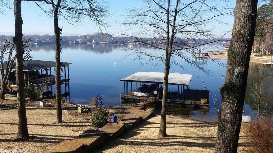 Classic Lake Home with Huge Lake Views. Room for all of you friends and family. Entertainment areas scattered throughout this home. Nicely updated with additional square footage added in Sunroom and Dining. Both have outstanding lake views. Downstairs den is a large room with adjoining full bath, and is currently used as living/master bedroom area. Water Heater is 50 gal Gas. Pellet Stove in the sunroom, fireplace in upstairs living area is woodburning. Fireplace downstairs is ventless gas logs.