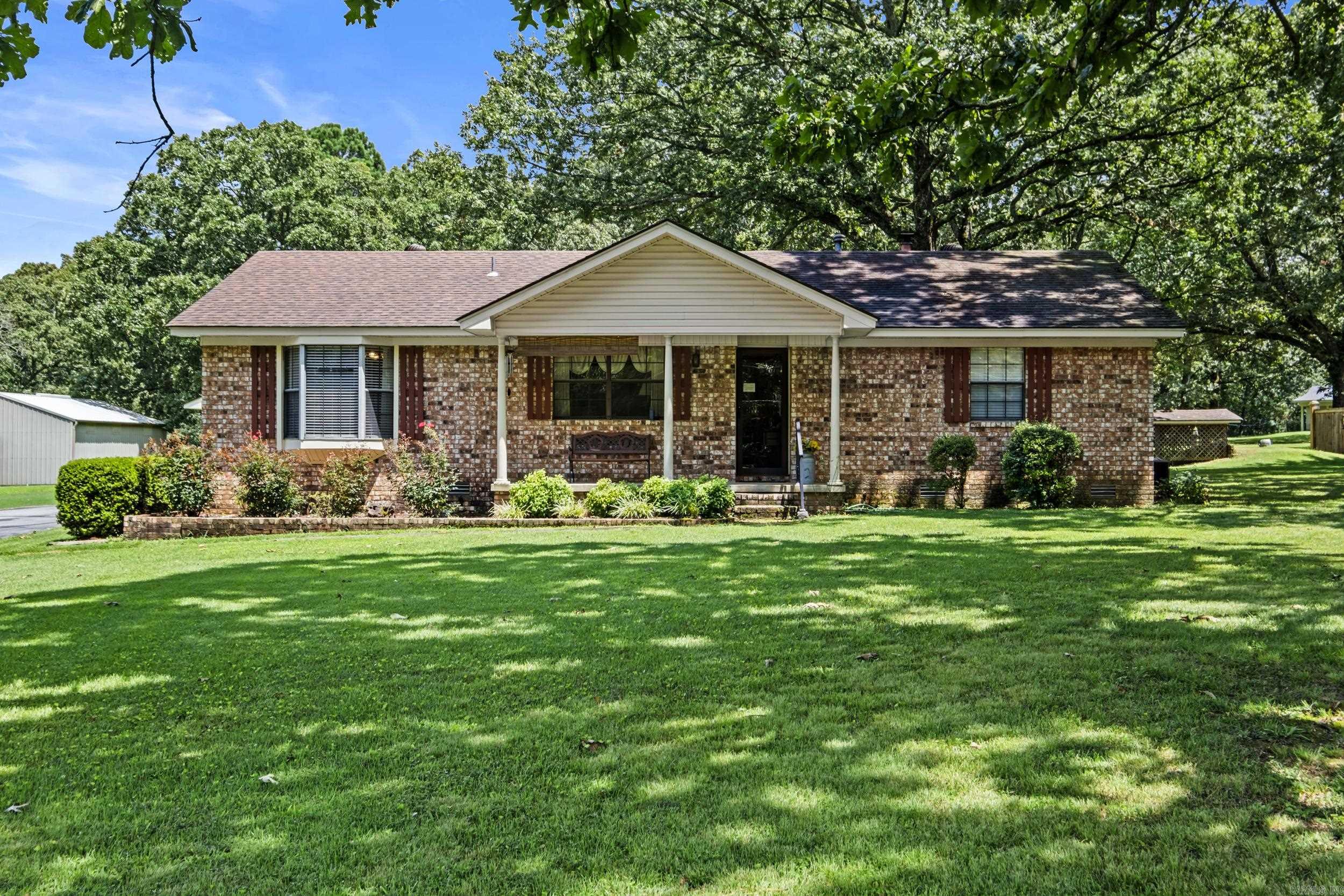 An EyeCatcher! This property has all kinds of curb appeal! 3 bdrm 2 bath home with 1500 sq ft of efficiency. Pull into this long driveway and park in the back of the home under the carport of pull directly into a shop. There are several other outbuildings for your toys, gardening tools or just storage. The large shade trees and the manicured yard makes this property desirable property in my book! The inside of the home is very clean. This is a great starter home or for anyone down sizing. Don't let this one slip away. Roof is approx 10 yrs old, HVAC is approx 10 years old New water heater.