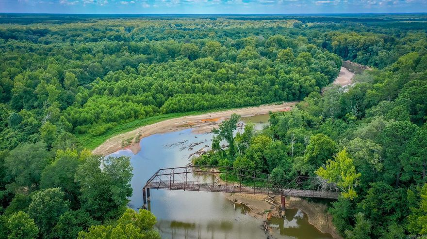 400 acres + or - of pure enjoyment! Excellent property for hunting lodge, church camp or other! Lots of BIG deer and plenty of turkeys and hogs!! Great for duck hunting. Rolling hills and deep draws that border I 30 and Little Missouri River on Clark and Nevada county side of river. Lots of pine and hardwood timber. Rowdy Adventures lodge, two large shops and five sheds, two older mobil homes and one double wide. Possibilities are endless as to what you could do with 400 acres - including endless Commercial possibilities!!!