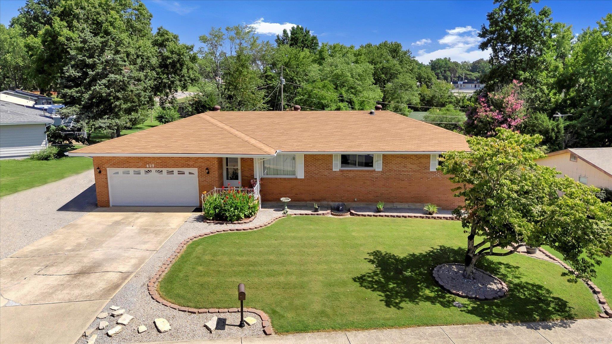 TONS OF SPACE in this beautifully updated all-brick 3-bedroom, 2.5-bath residence nestled in a quiet subdivision on a .32-acre corner lot. Boasting a heated and cooled sunroom, full basement, workshop, storage and a secure storm room, this home offers comfort and peace of mind. The expansive 2-car garage is complemented by an additional garage stall on the lower level. Enjoy the brand-new 10x16 storage shed. Inside, enjoy all-new 2023 high-end appliances, HVAC, ductwork, electrical, and new bedroom windows. Fresh professional landscaping enhances the elegant curb appeal. Abundant storage throughout. Conveniently located near the hospital and medical facilities, this exceptional home is the perfect blend of charming style, and functionality. Buyer to verify all measurements and square footage.