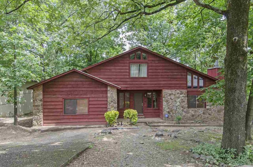 This Rustic Cedar Beauty sits on a wooded lot, has 2 cozy bedrooms upstairs, spacious master bedroom downstairs, Stainless Steel Kitchen appliances,  bonus room, deck, workshop with electricity. New roof in 2011.