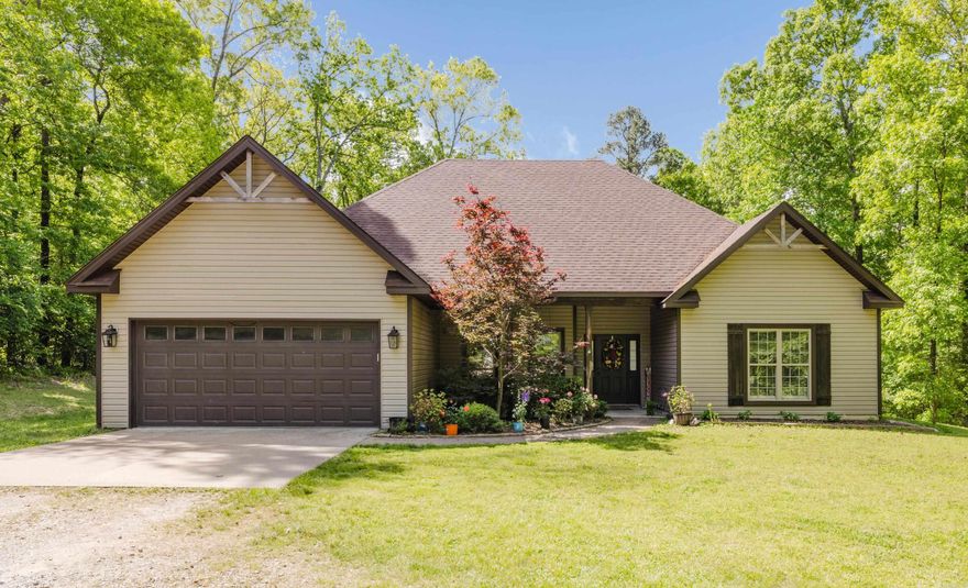 Tucked away on 2.9 peaceful, tree-surrounded acres, this beautifully maintained 4-bedroom, 2-bath home offers the perfect blend of privacy and modern comfort. Step inside to an open floor plan designed for easy living and entertaining, highlighted by a spacious living room with an elegant tray ceiling. The kitchen with white cabinets features granite countertops, ample storage, and a seamless flow into the main living and dining areas. Enjoy the outdoors year-round with a large deck and a covered back porch—ideal for relaxing or hosting gatherings while taking in the quiet, natural setting. Additional highlights include a new roof (2024) and a serene location that offers both space and tranquility, all while still being conveniently located. This property is the perfect place to call home!