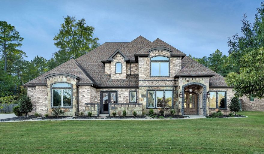 Stunning home in Hurricane Lake Estates(gated area). Brick & stone. The grand entrance & extensive trim will follow through out the home. Hdwds, double f/p to family area & office. Coffered & Tray ceilings. Eat in kitchen w/slab granite, SSA Copper sink, Wet bar, pantry & custom cabinets. Bullnosed/arched. Master w/sitting area. Master bath jetted tub, double vanities, WC, stand up shower & safe room. Each bedroom has full bath & walk in closets. Bonus wired for projection. Large lot, fenced & private.