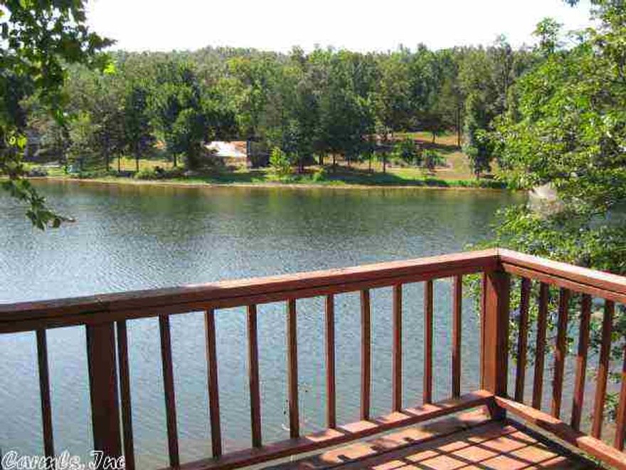 LAKEFRONT A-Frame has nice deck overlooking Private lake.  NEW metal roof 2015.  Outside of city limits but very close to Griffin Park, and highway for schools and shopping.  Open living/dining/kitchen on main level with full bath.  Sliding glass door opens onto deck which you can practically fish from.  Windo unit provides both heat and air, addl unit for air only upstairs.  Upper level is an open loft with built in headboard and shelving.  Perfect get away to enjoy surrounding river, lakes and shops!