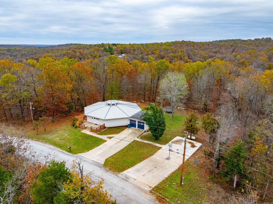 Discover this spacious and versatile 5,572 sq. ft. home with 2 bedrooms and 2 baths on the main floor, plus a fully finished basement offering 3 additional rooms currently used as bedrooms—ideal for a large or growing family. With the potential for up to 5 bedrooms, and the 3rd bathroom in the basement, along with a large entertainment/gathering area also located in the basement area, this home provides plenty of space to accommodate family and guests. Enjoy convenient parking with an attached 2-car garage and a second driveway where a detached 2-car garage once stood, allowing space to add a large garage or workshop. Relax on the expansive wrap-around deck, which offers a seasonal lake view during fall and winter. Located just minutes from Ash Flat and downtown Cherokee Village, this home offers privacy with a peaceful, secluded feel. An extra spacious living area adds even more flexibility to suit your lifestyle.